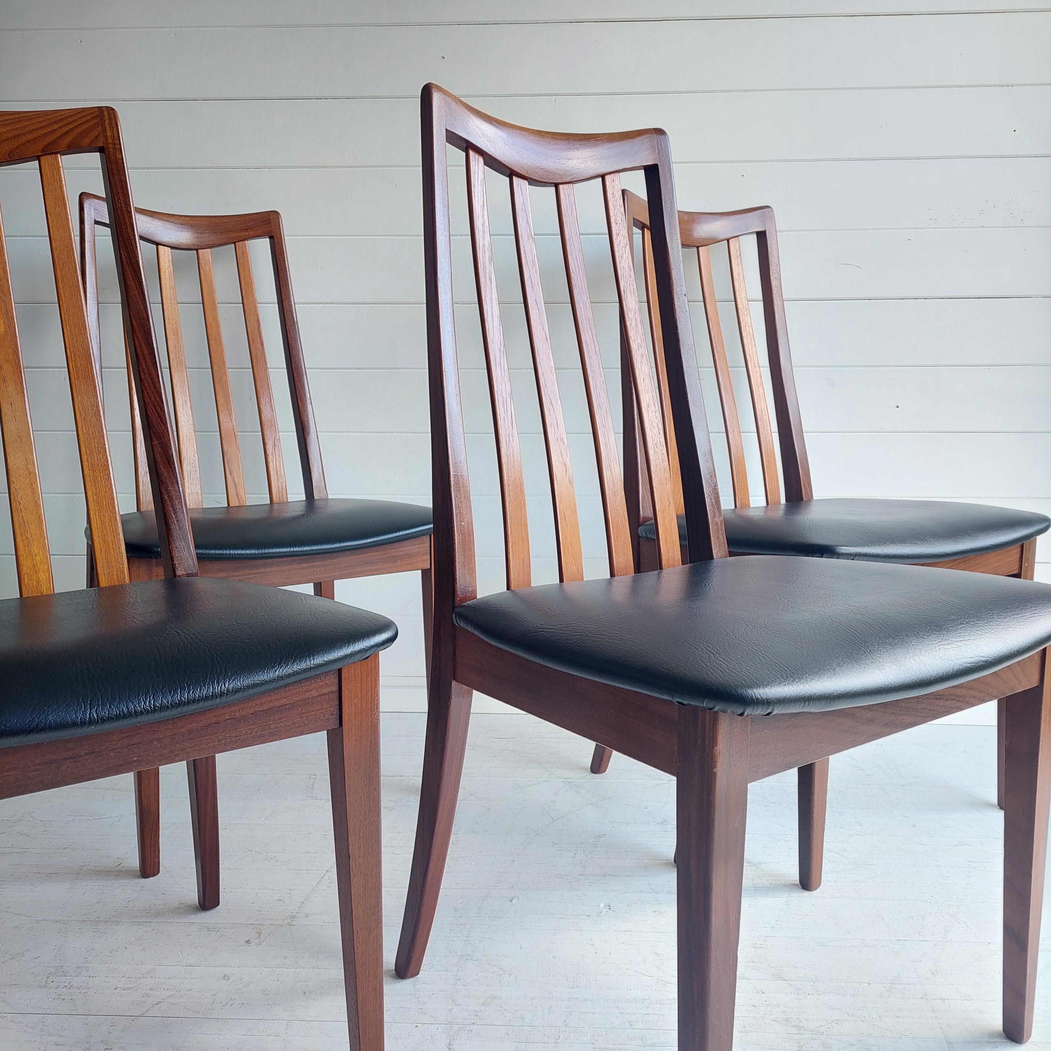 Stylish & sought after dining chairs, lovely rich solid teak chairs designed by Victor Bramwell Wilkins with stunning grain complemented with black faux leather seat pads. 
Fresco range dining chairs. Stunning midcentury design.
Very eye catching
