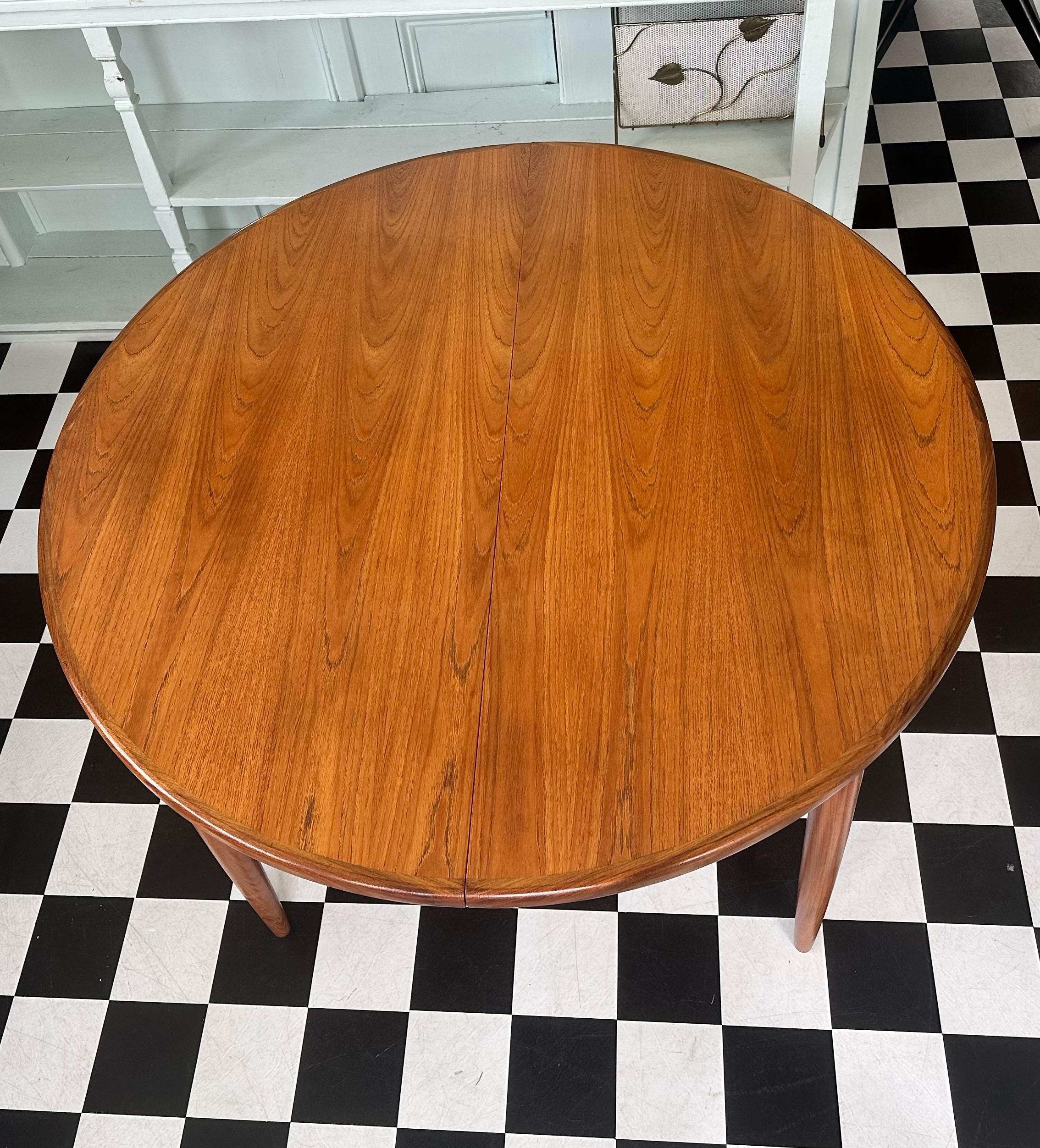 This beautiful G Plan Fresco teak dining table showcases an exquisite design with a rich teak grain. It features an extending butterfly leaf that tucks away neatly when not in use, offering both practicality and style. The round shape comfortably