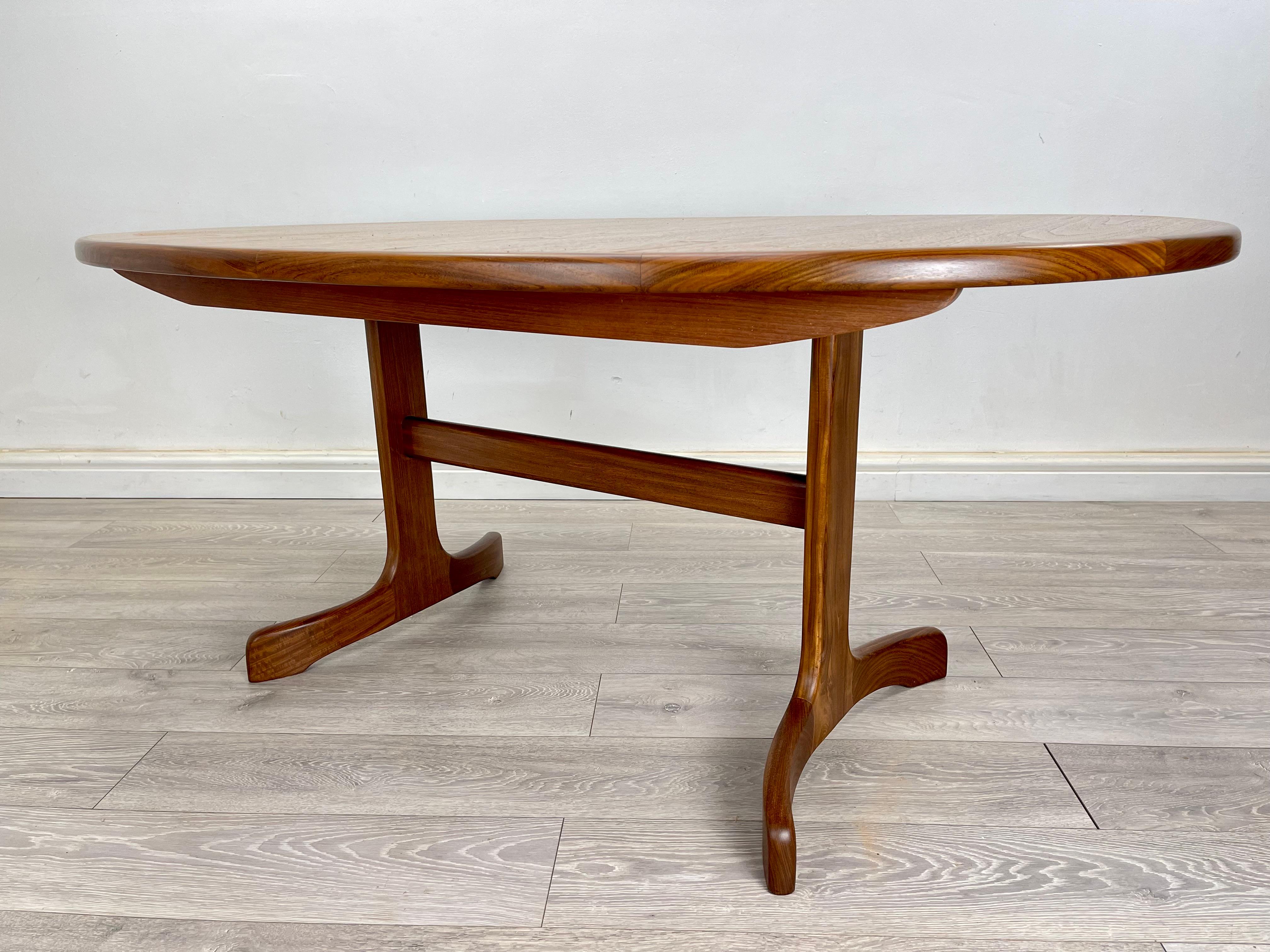 DINING TABLE 
Mid century teak oval extendable dining table made by G Plan circa 1970 . The table has stunning teak grain throughout , there’s a single extension leaf which neatly folds underneath the table .

DIMENSION 
Height- 72 cm 
Depth - 107cm