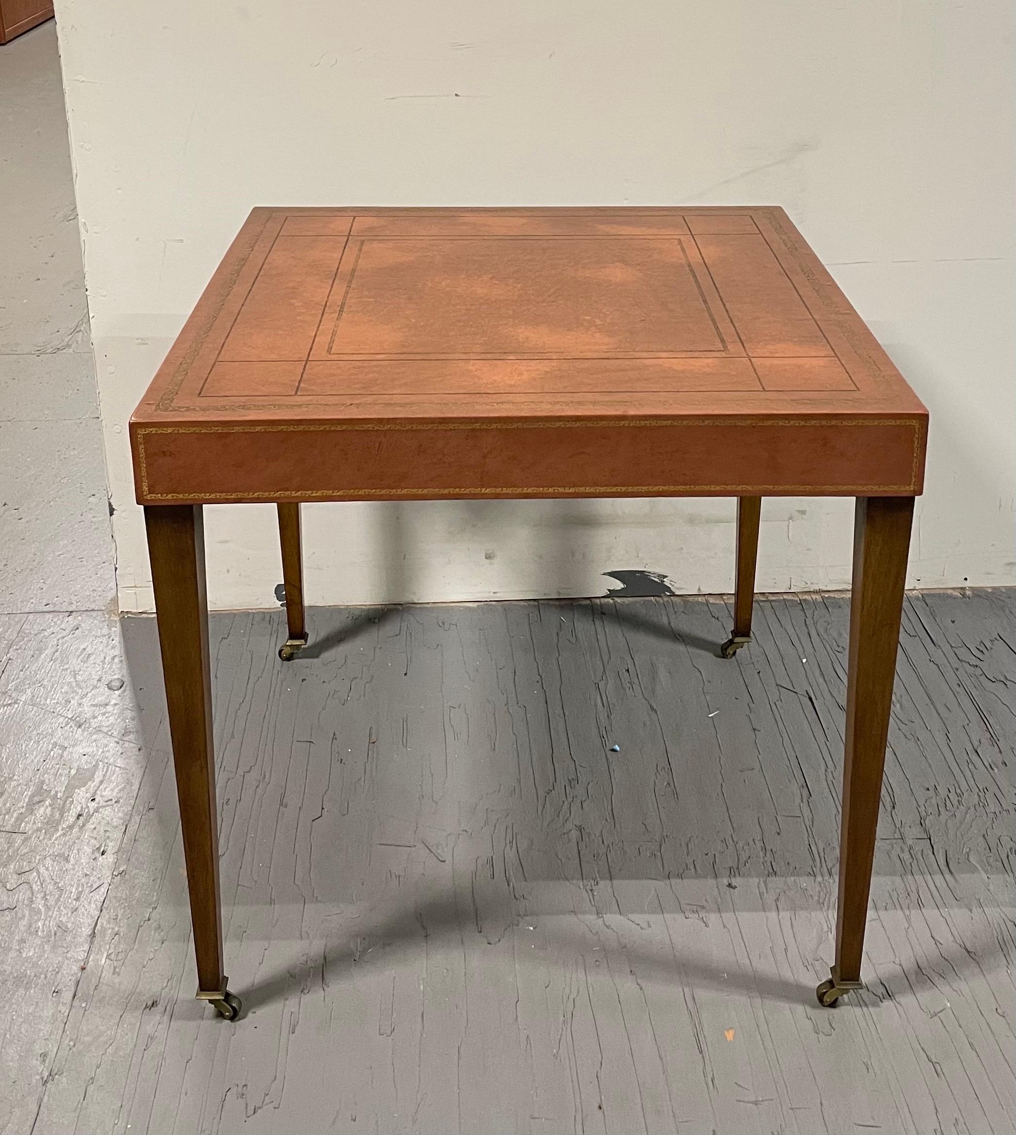 Elegant Tooled Leather Top Game table in the manner of Tommi Parzinger. Great modern linear design. Boxed leather top offset nicely by tapered Hepplewhite style legs and brass casters.
Curbside available to NYC/Philly $350.