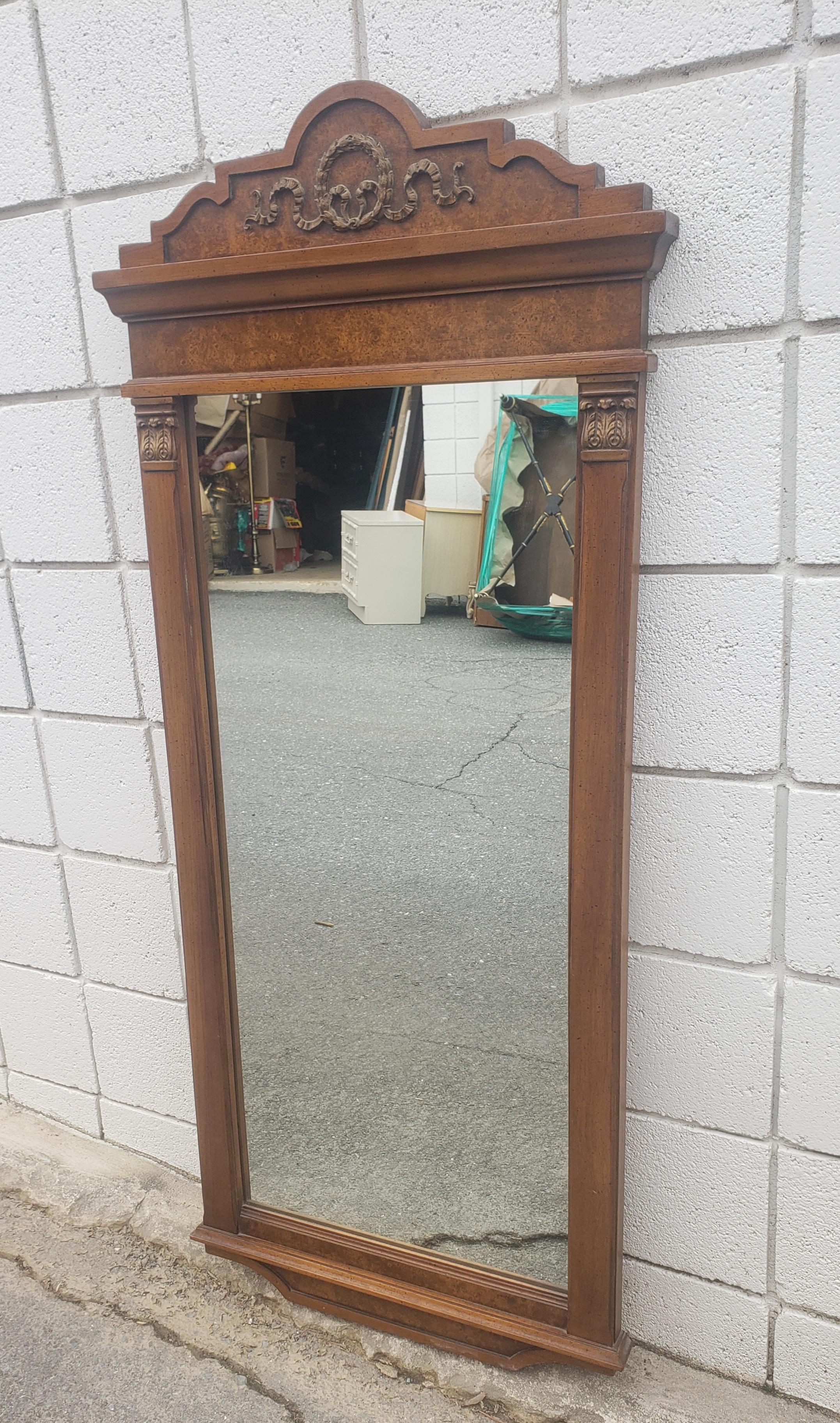 A midcentury burl walnut and giltwood ornate wall mirror by Gardner Mirror of North Wilkesboro, North Carolina. Very good condition with wood backing.