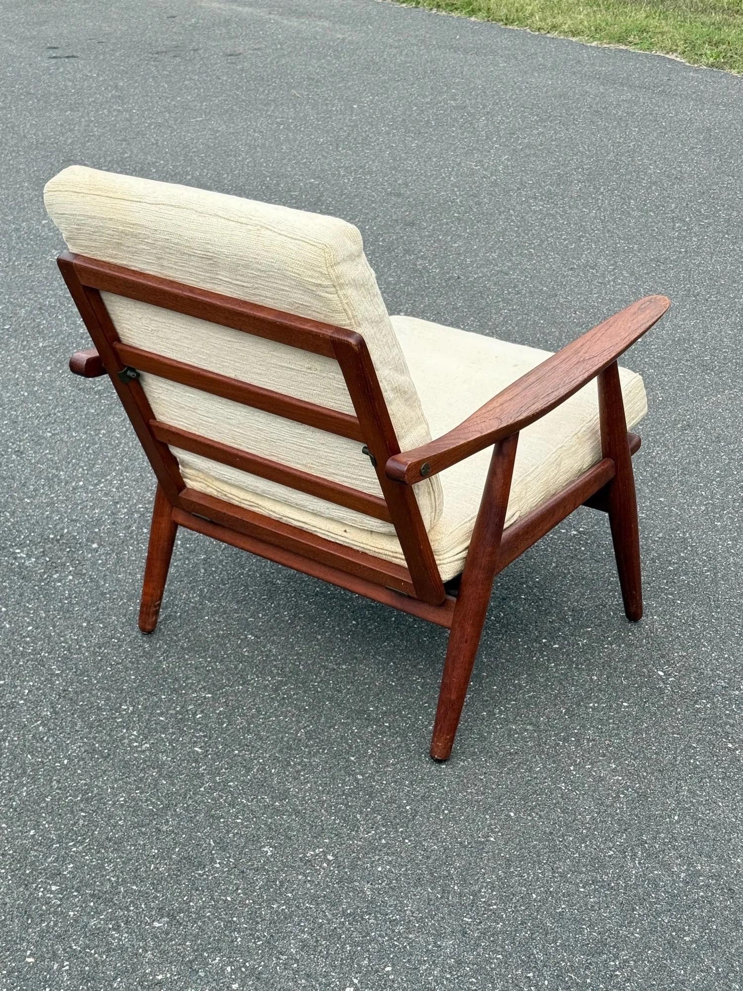 Ein Paar Lounge-Sessel des Modells GE-70, entworfen von Hans J. Wegner für Getama, Dänemark. Ein atemberaubendes Paar aus geschnitzten Teakholzrahmen in einem warmen Holzton. Die Rahmen im klassischen dänischen Stil sind stromlinienförmig, ohne zu