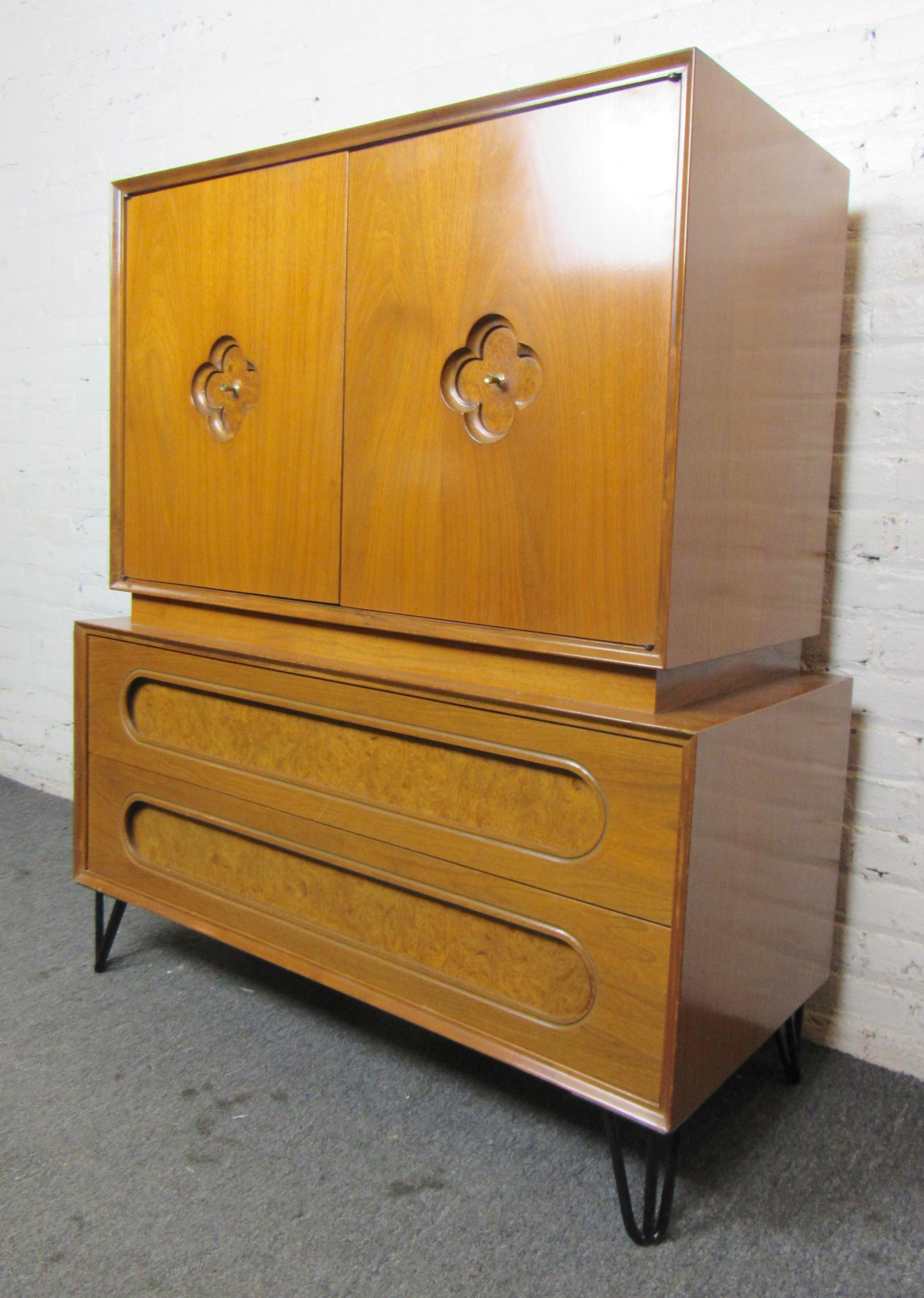 Mid-century modern tall chest of drawers with hidden storage. Large bottom drawers and three hidden drawers. Lovely inset burl with brass pulls on each door.
(Please confirm item location - NY or NJ - with dealer).
 