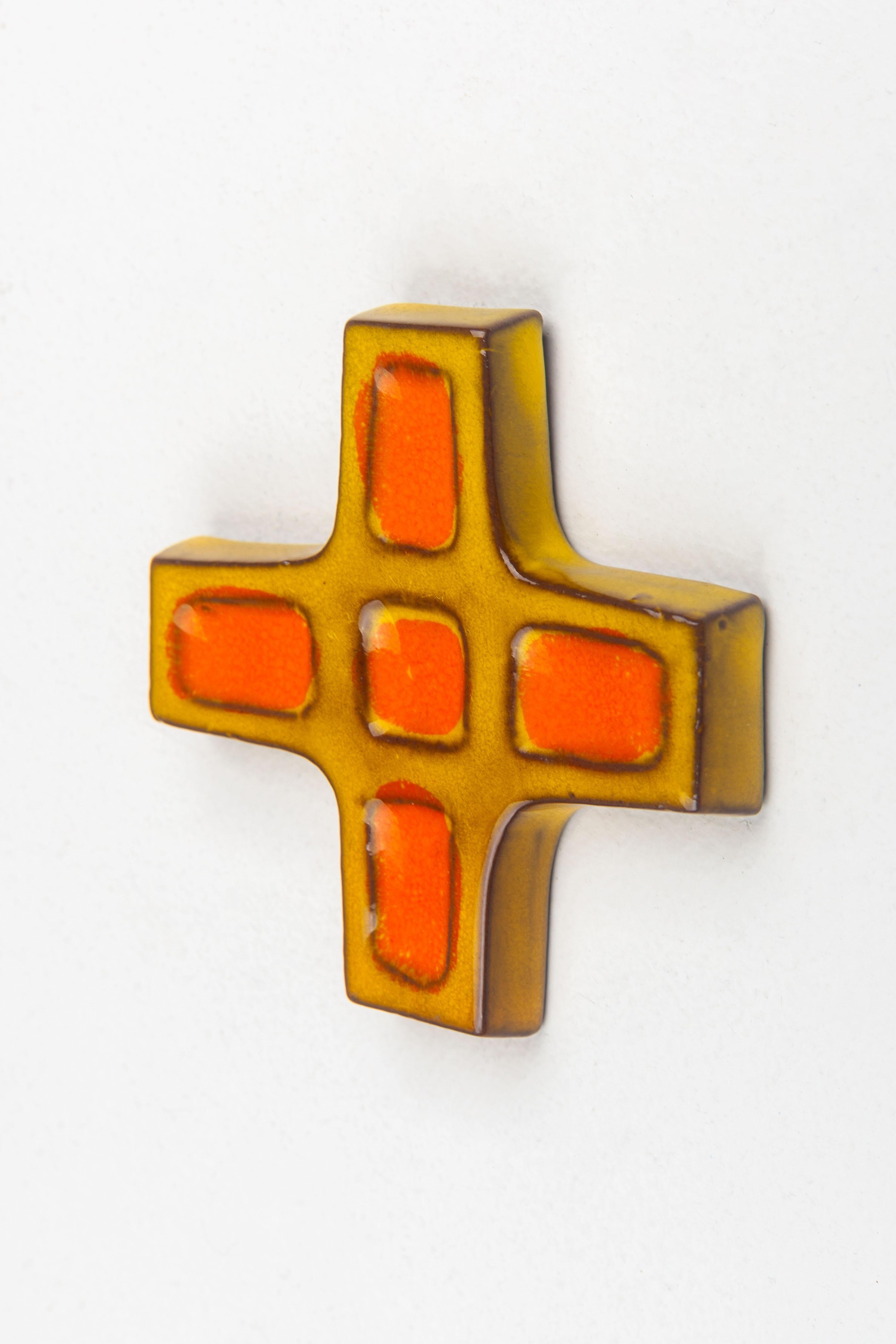 This ceramic cross epitomizes the geometric abstraction that was prevalent in mid-century modern design. Handcrafted by European studio pottery artists, the cross is a celebration of form and color. It features a series of recessed rectangles filled