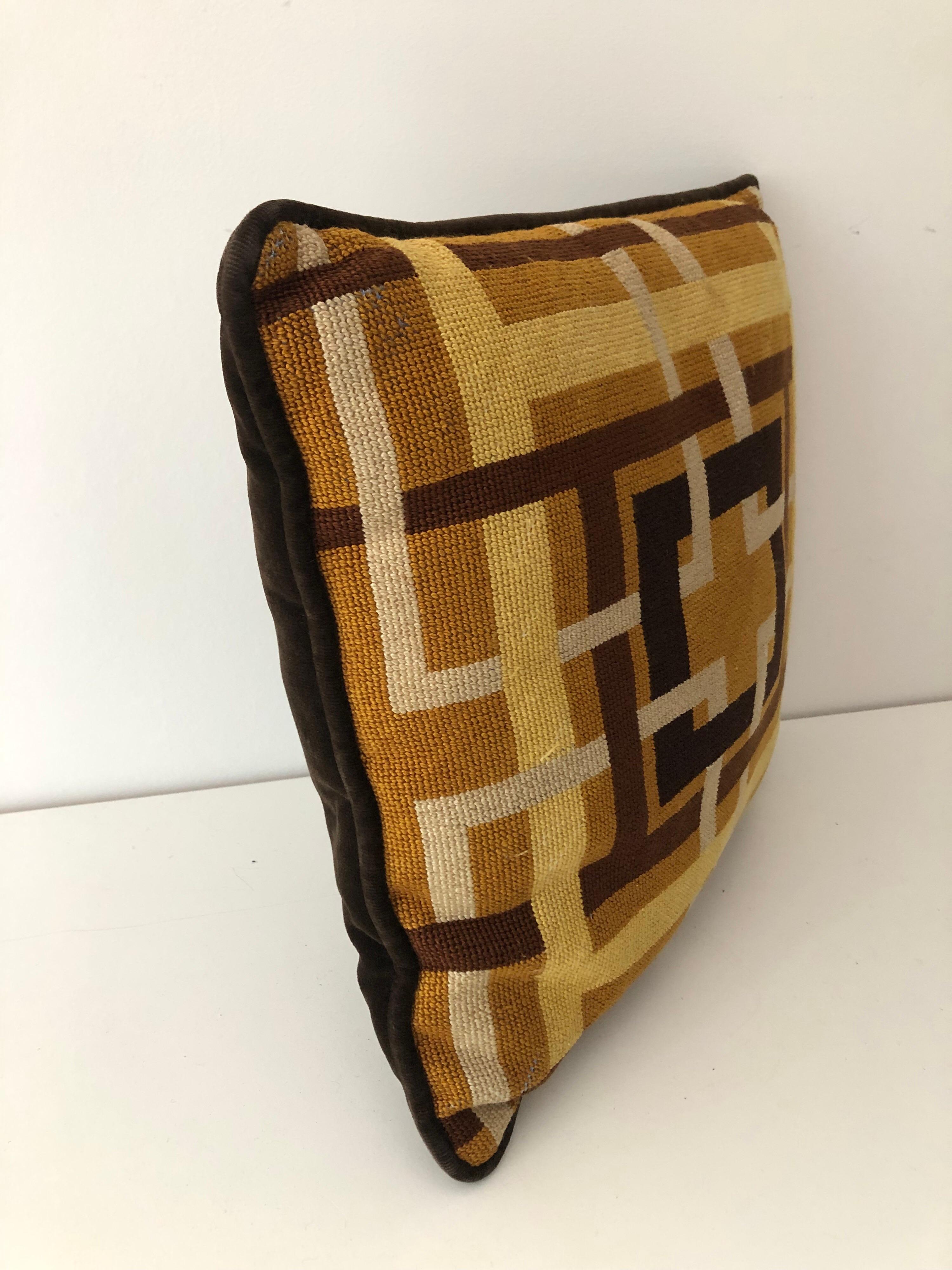 A midcentury geometric grid print needlepoint pillow in neutral tones with brown velvet back. Two additional associated pillows available.