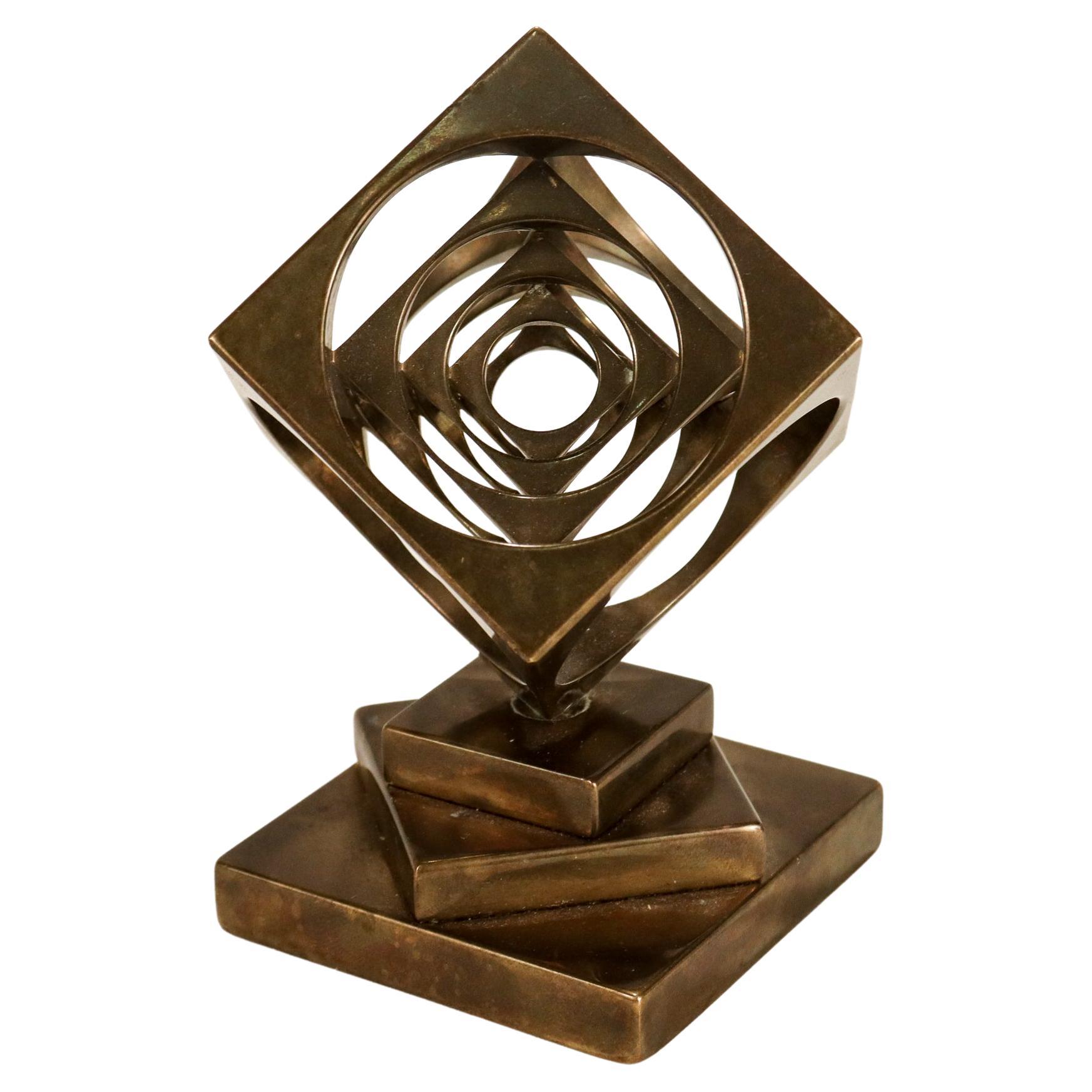 A fine midcentury geometric bronze paperweight for the desk.

In the form of a turner's cube of graduated cubes within cubes.

Mounted on a machined plinth of graduated squares.

Secured to the plinth with a steel screw.

Simply a wonderful
