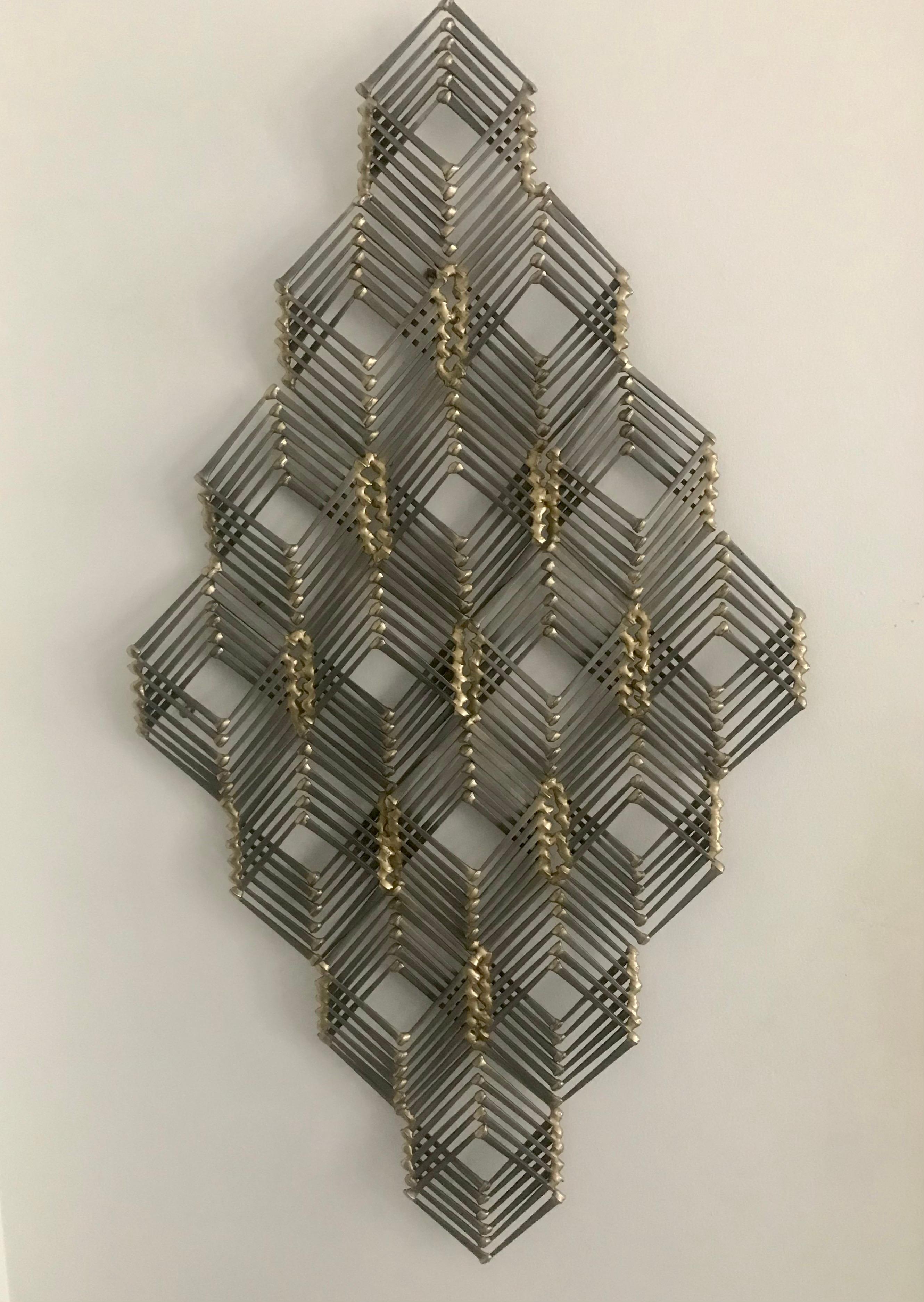 Lacquered metal nail and brass wall sculpture can be hung vertically or horizontally.