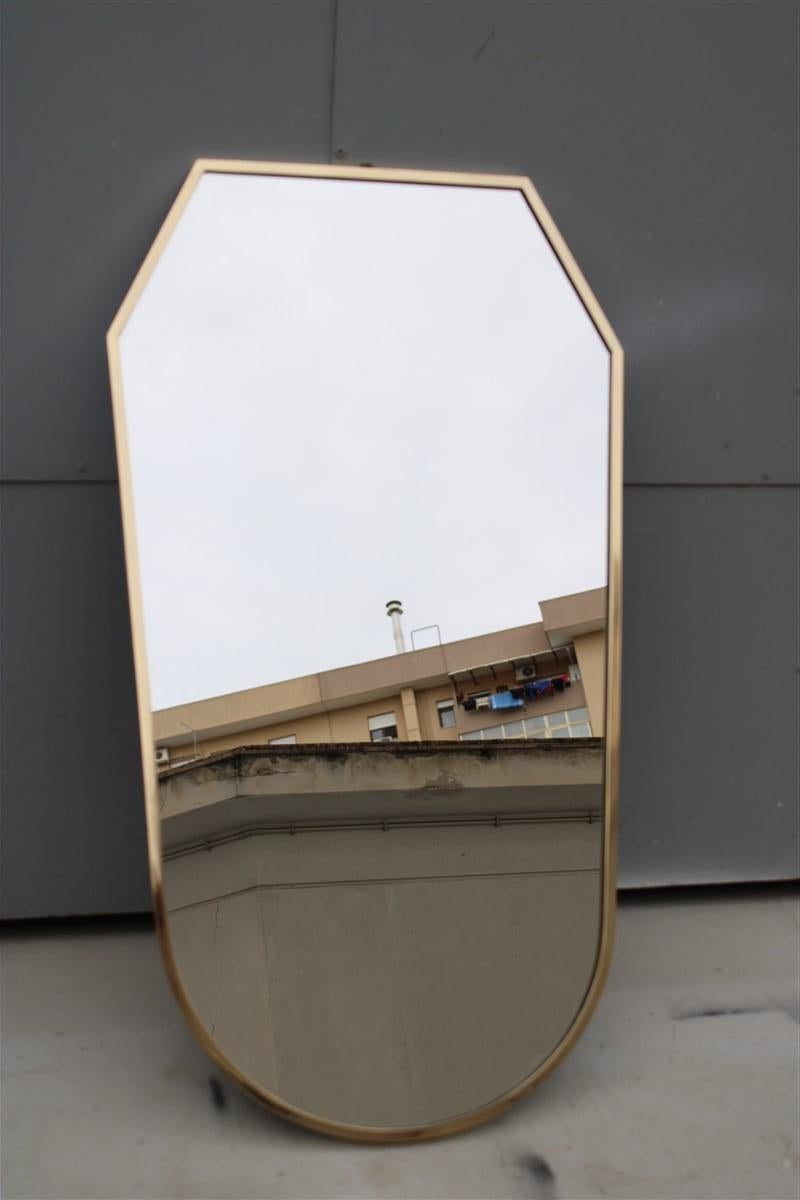 Midcentury geometric shape wall mirror in solid brass 1950s made in Italy.