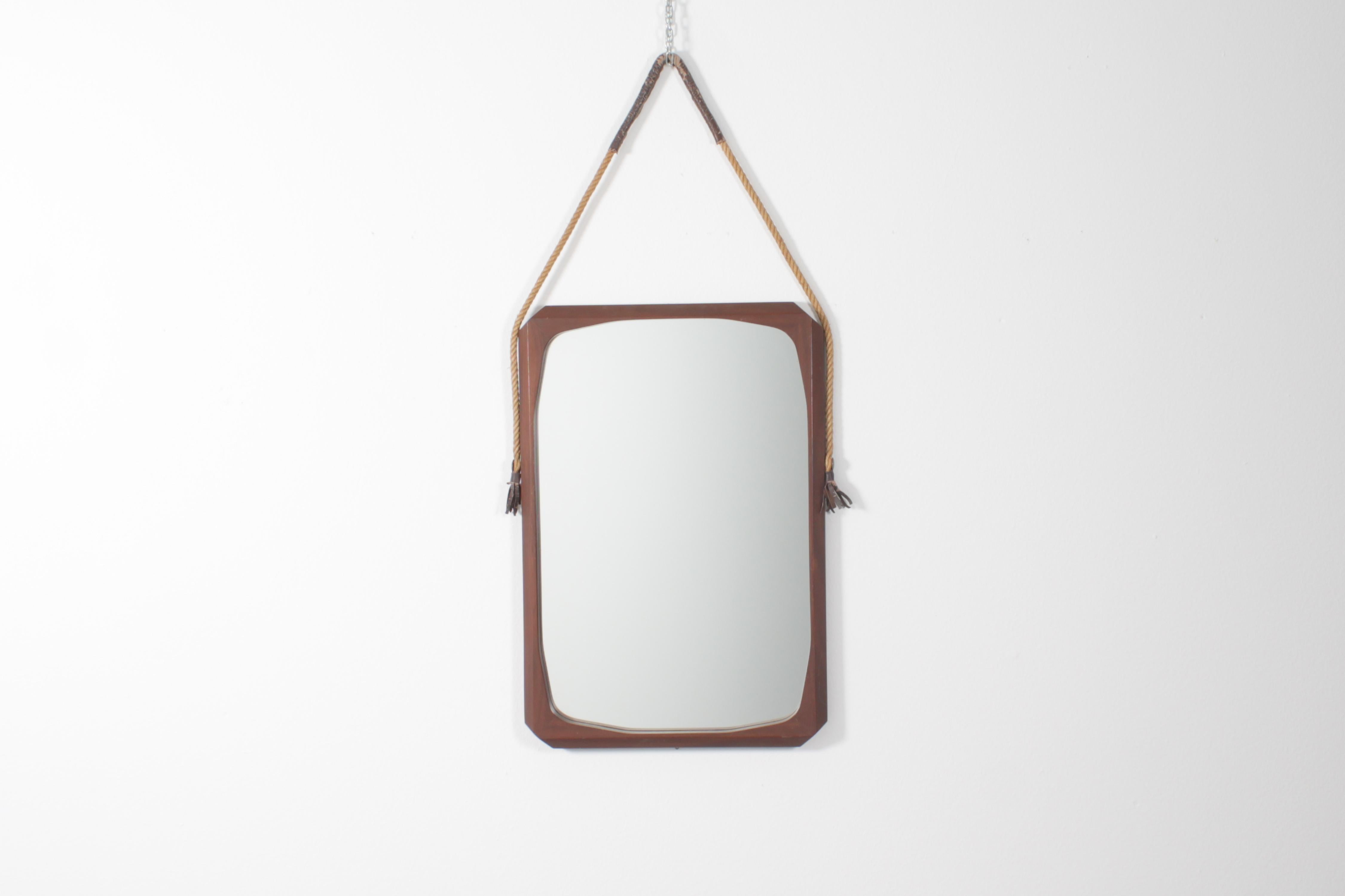 Nice geometric wall mirror with rectangular wooden frame with beveled corners and rope with eco-leather elements, for hanging.
Italian production from the 70s.
Wear consistent with age and use.