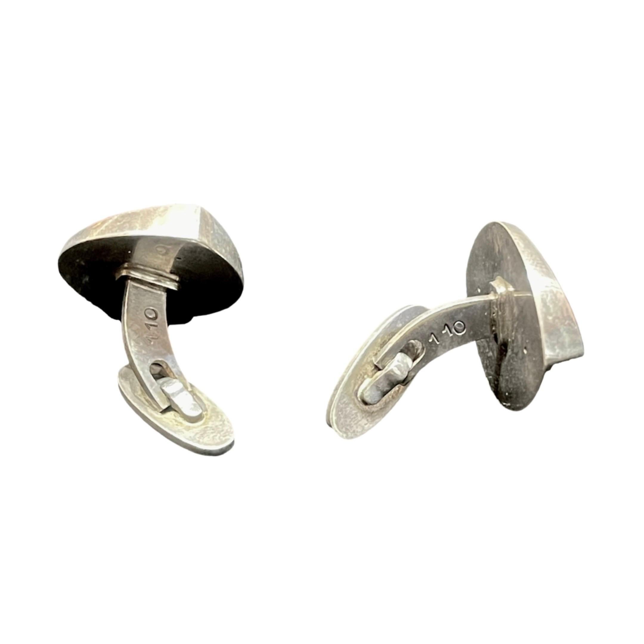 We have a stunning pair of Georg Jensen Sterling Silver Modernist oval-shaped cufflinks in pattern number 110 that are rare and beautiful. Nanna Ditzel designed these cufflinks in the 1960s, and this particular design was made in various sizes, with