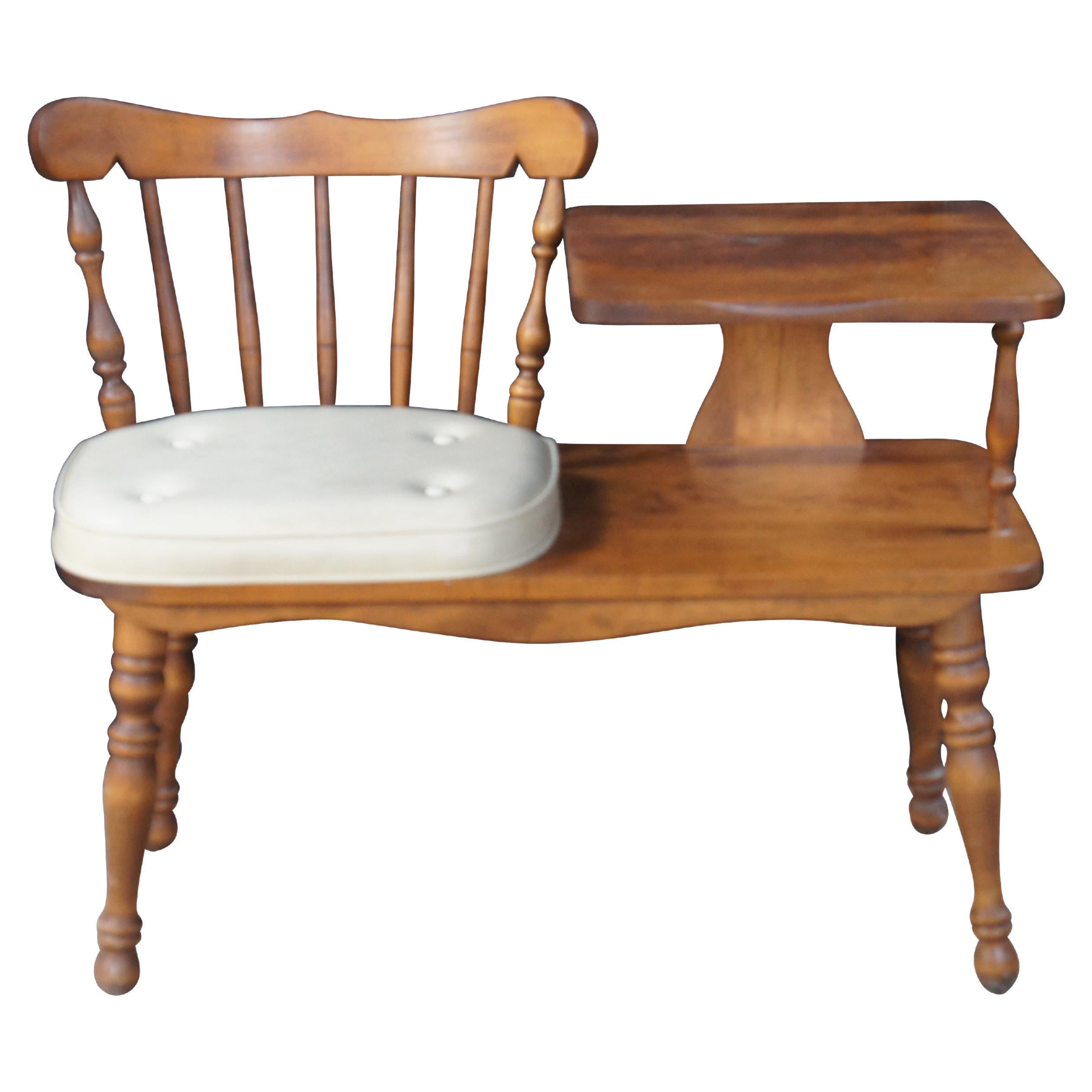 Mid to early 20th century George B Bent Co Inc telephone bench.  Made of Hard Rock Maple featuring Colonial and early American styling with a slat back seat next to a two tiered tray table supported by turned legs.  

George B. Bent Co. was known