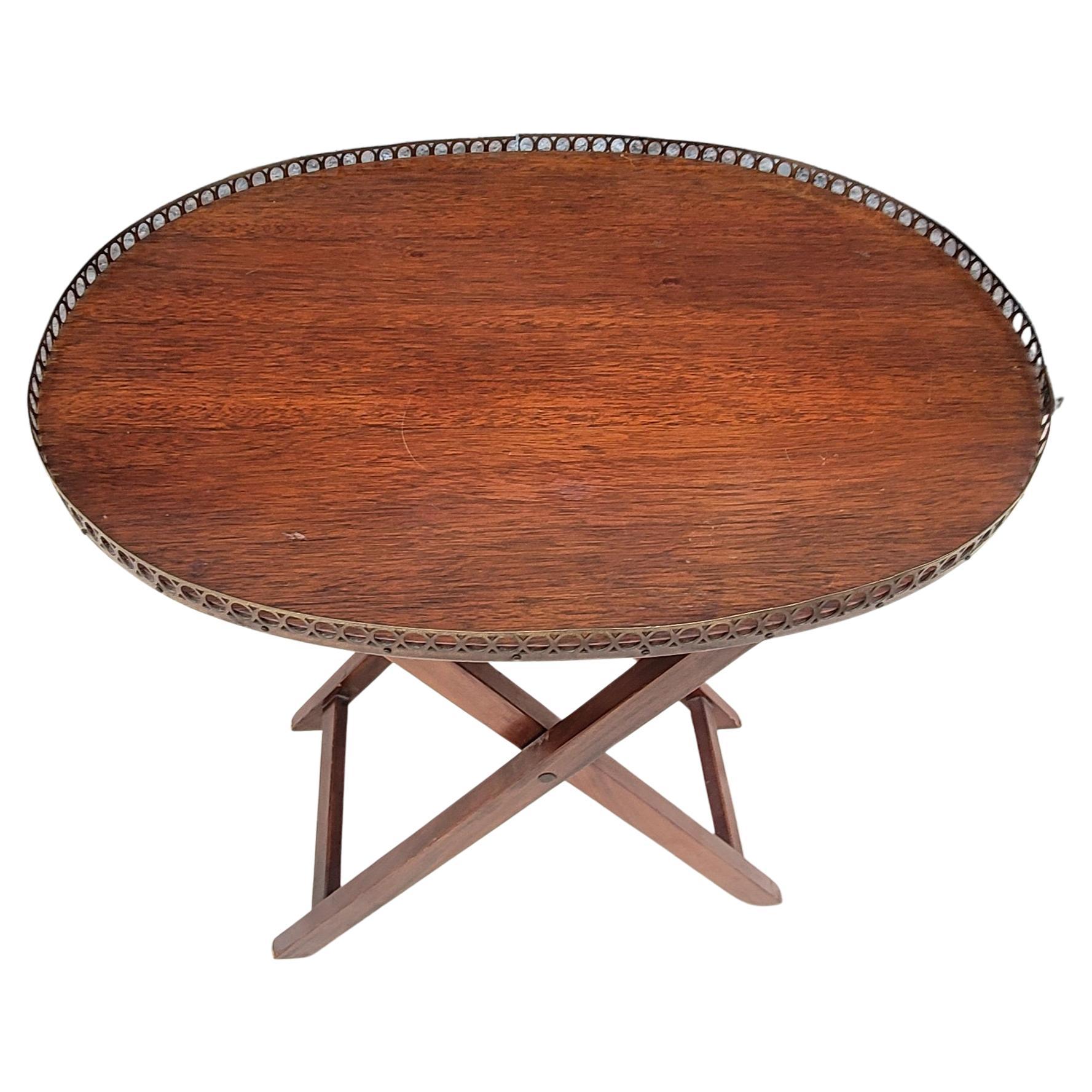 A mid century George III style mahogany folding serving tray with metal gallery.