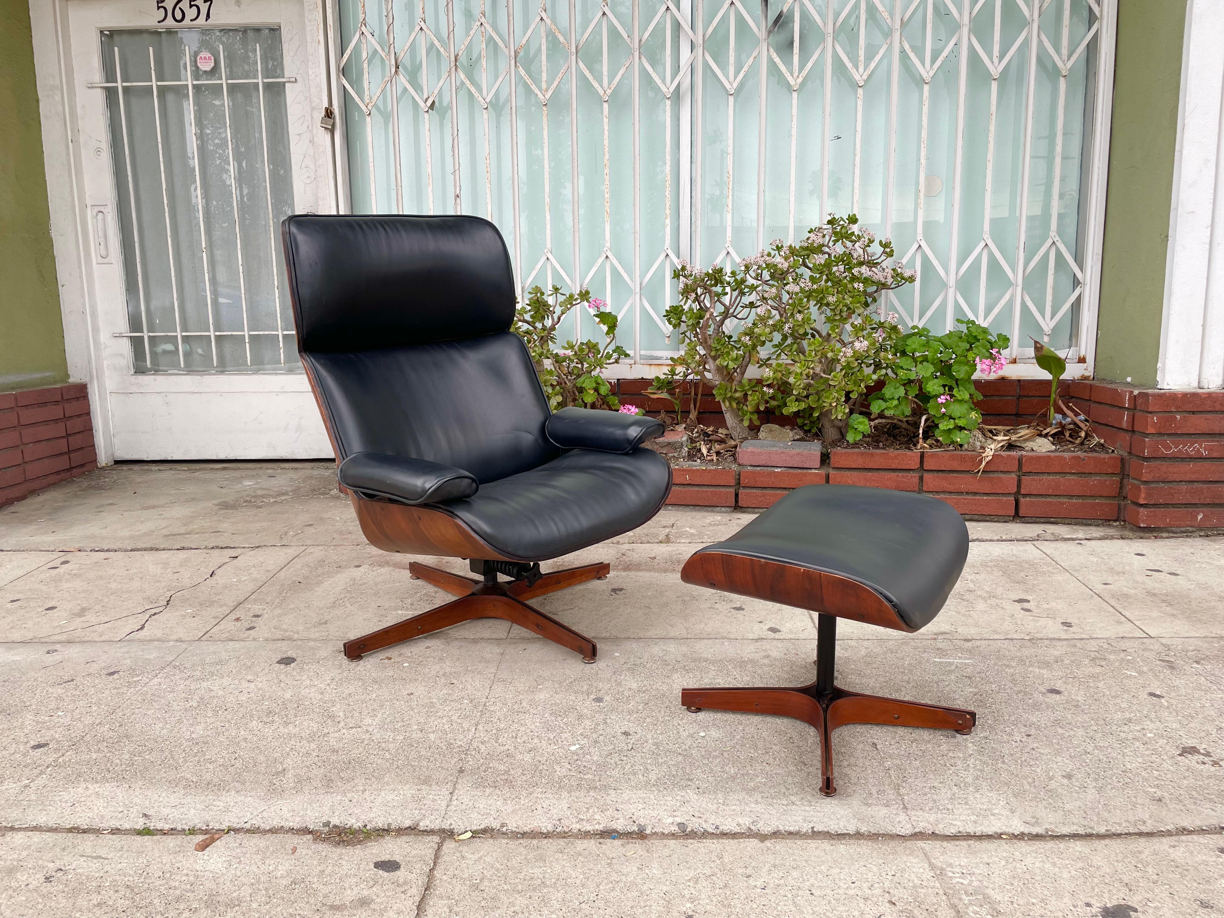 Beautiful midcentury lounge chair & ottoman designed by George Mulhauser and manufactured by Plycraft. This vintage chair and ottoman have a distinctive design and excellent representation of the midcentury era. The chair has a walnut frame wrapped