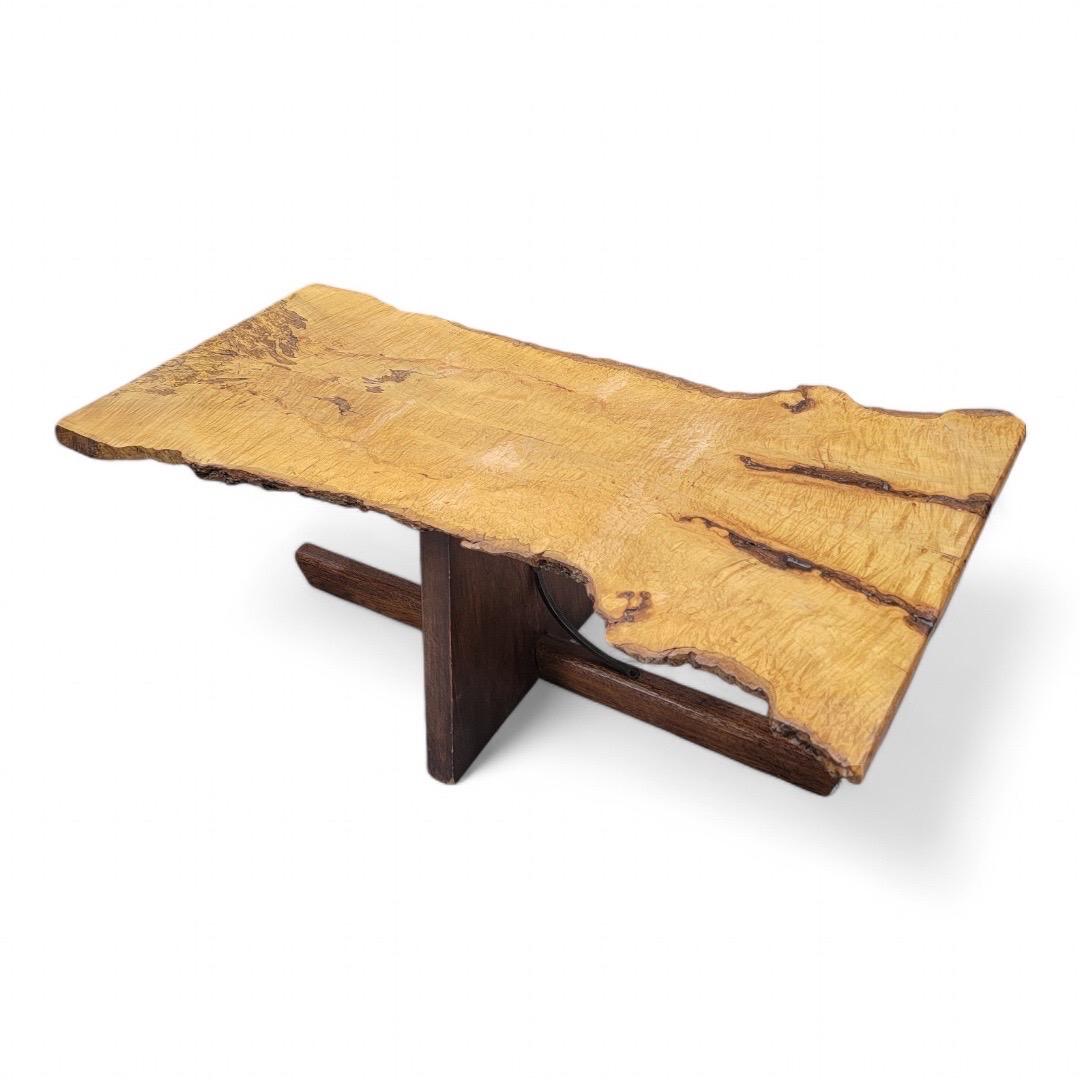 Mid-Century George Nakashima style Live Edge Coffee Table

Your rustic natural interior would look perfect with this coffee table. The table top is constructed from a live edge slab of wood and a wooden pedestal base.
 