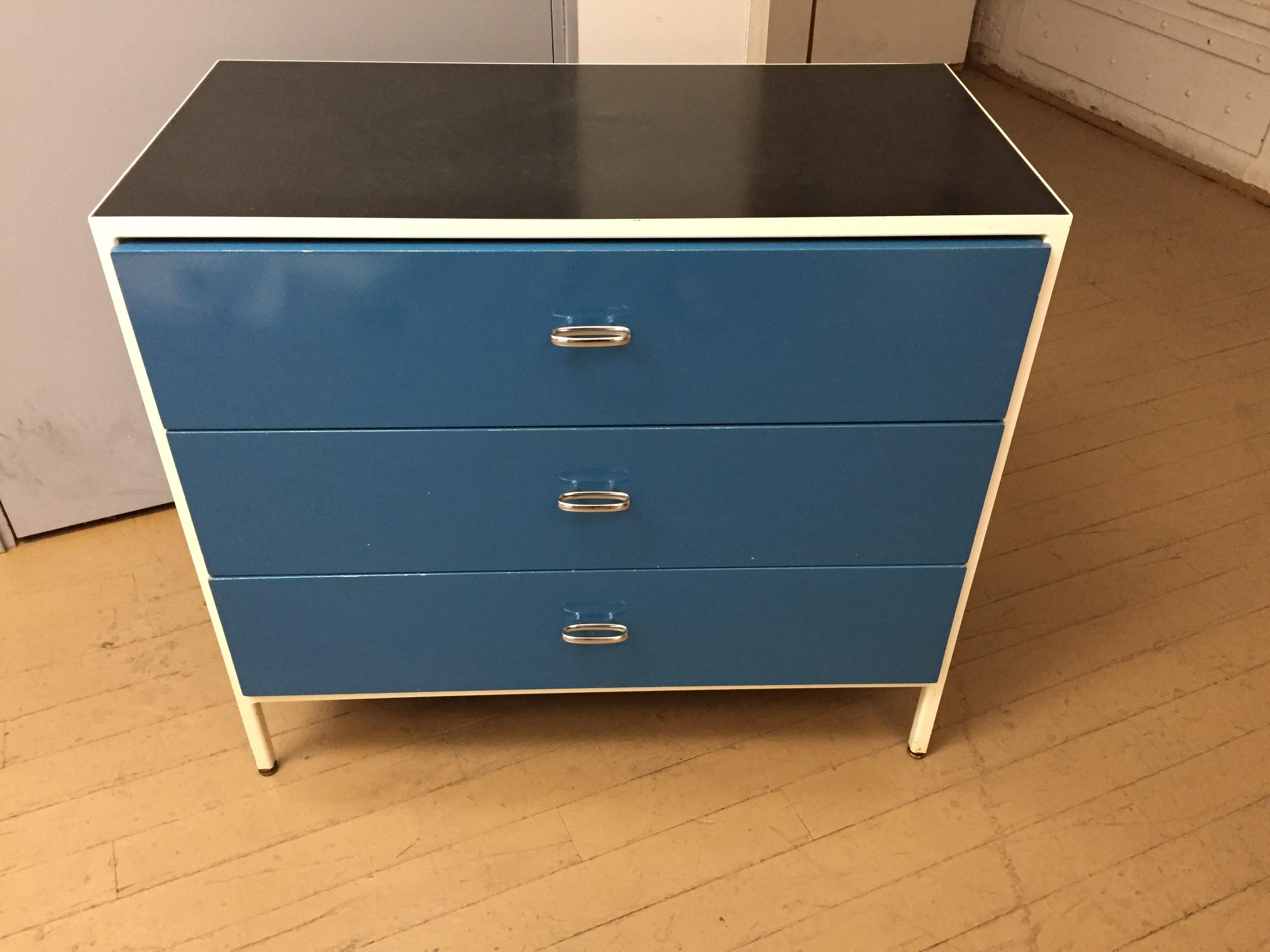 Mid-Century Modern George Nelson for Herman Miller Mid-Century Modern iconic pair of three-drawer chests from the steel frame series .
Created by George Nelson for Herman Miller with white enameled metal frames, black laminate tops, blue lacquered