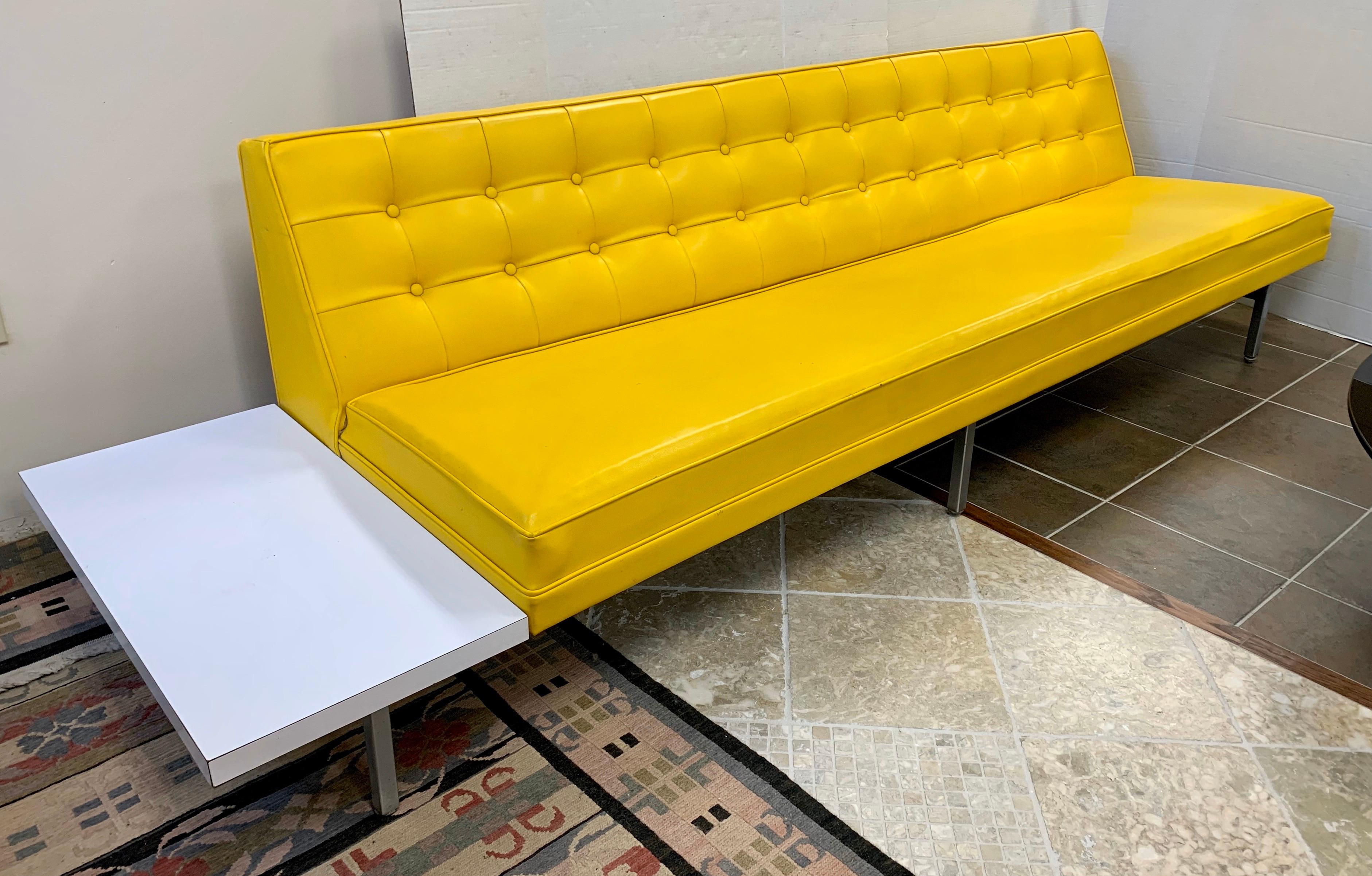 Elegant and iconic midcentury signed living room sofa designed by George Nelson for Herman Miller.
It features original banana yellow vinyl upholstery which is ultra rare and coveted.
The frame is made of chrome steel. It has an attached white