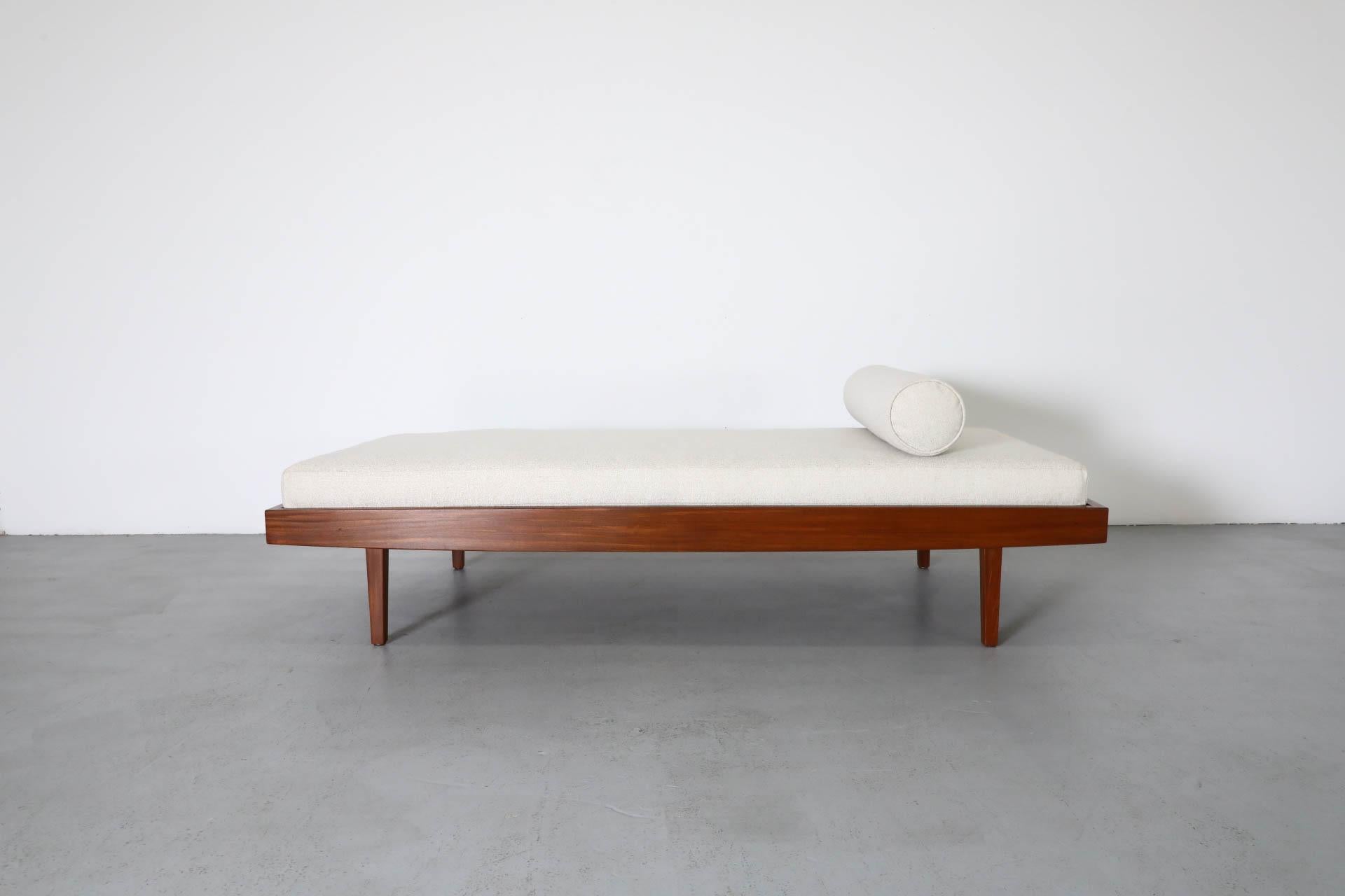 Dutch Mid-Century, George Nelson inspired daybed with a new beige upholstered mattress that rests on a slatted base and lightly refinished wood frame that is supported by matching, square wooden legs. Some frame wear consistent with age and use. 