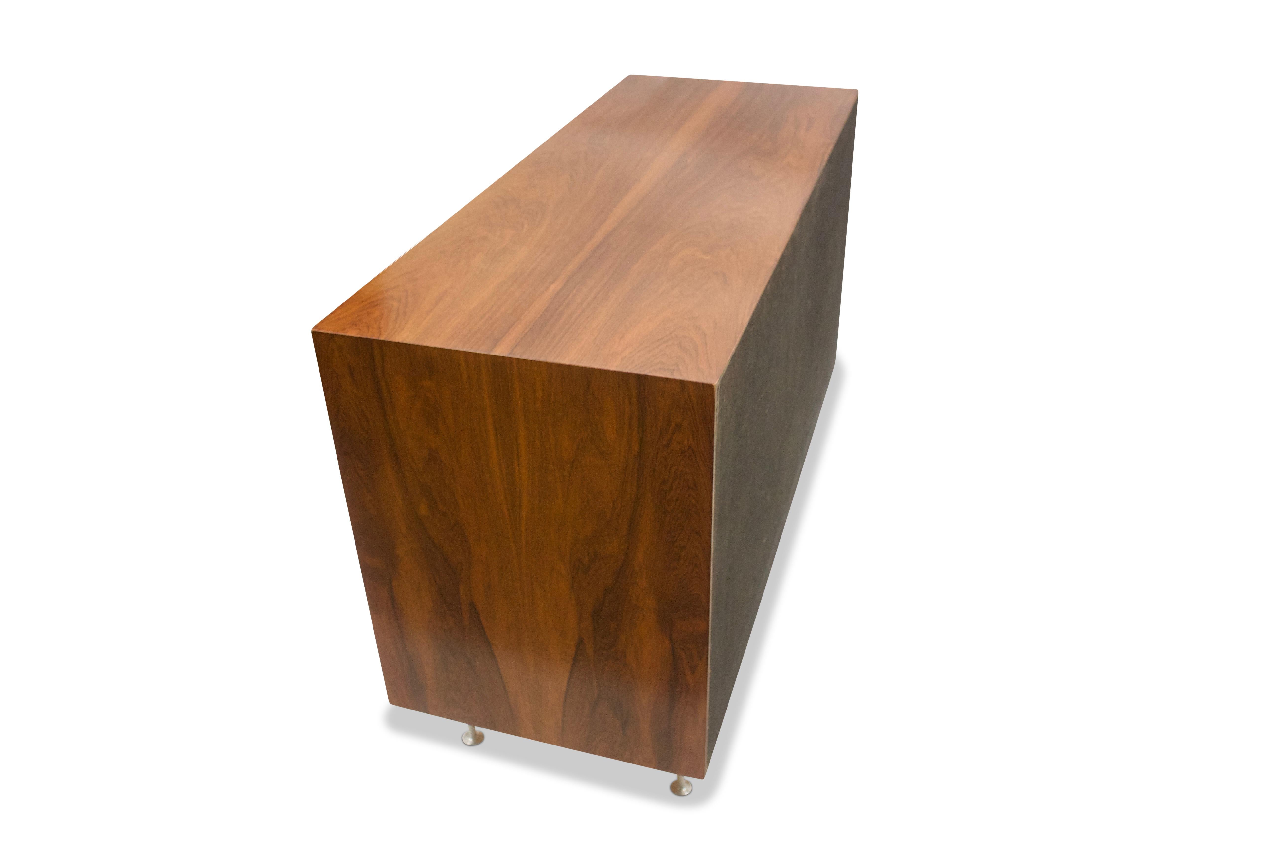 Nice, simple open plan storage cabinet by George Nelson for Herman Miller. The case, raised on four turned aluminium legs, is veneered in rosewood with each side having bookmatched grains. The interior, with two adjustable shelves.

 