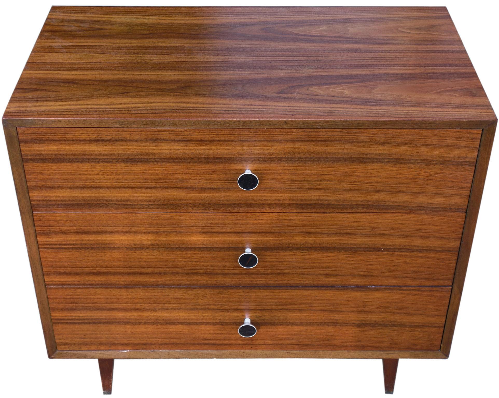 Beautiful midcentury three-drawer dresser by George Nelson for Herman Miller. Highly figured walnut almost has a rosewood appearance. Featuring the seldom seen pulls with ebony inlay. 

-Photos taken with natural light on a sunny day.