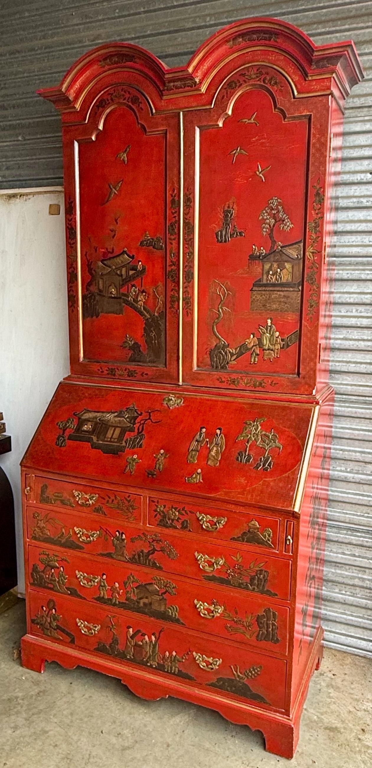 This is a Chinese red Georgian style chinoiserie secretary. It is a mid-century find that is heavily painted with pastoral scenes and go,t accents. It is most likely American and is unmarked. The base is 38”L x 20.75”W. Crown is 41”L x 12”W. The top