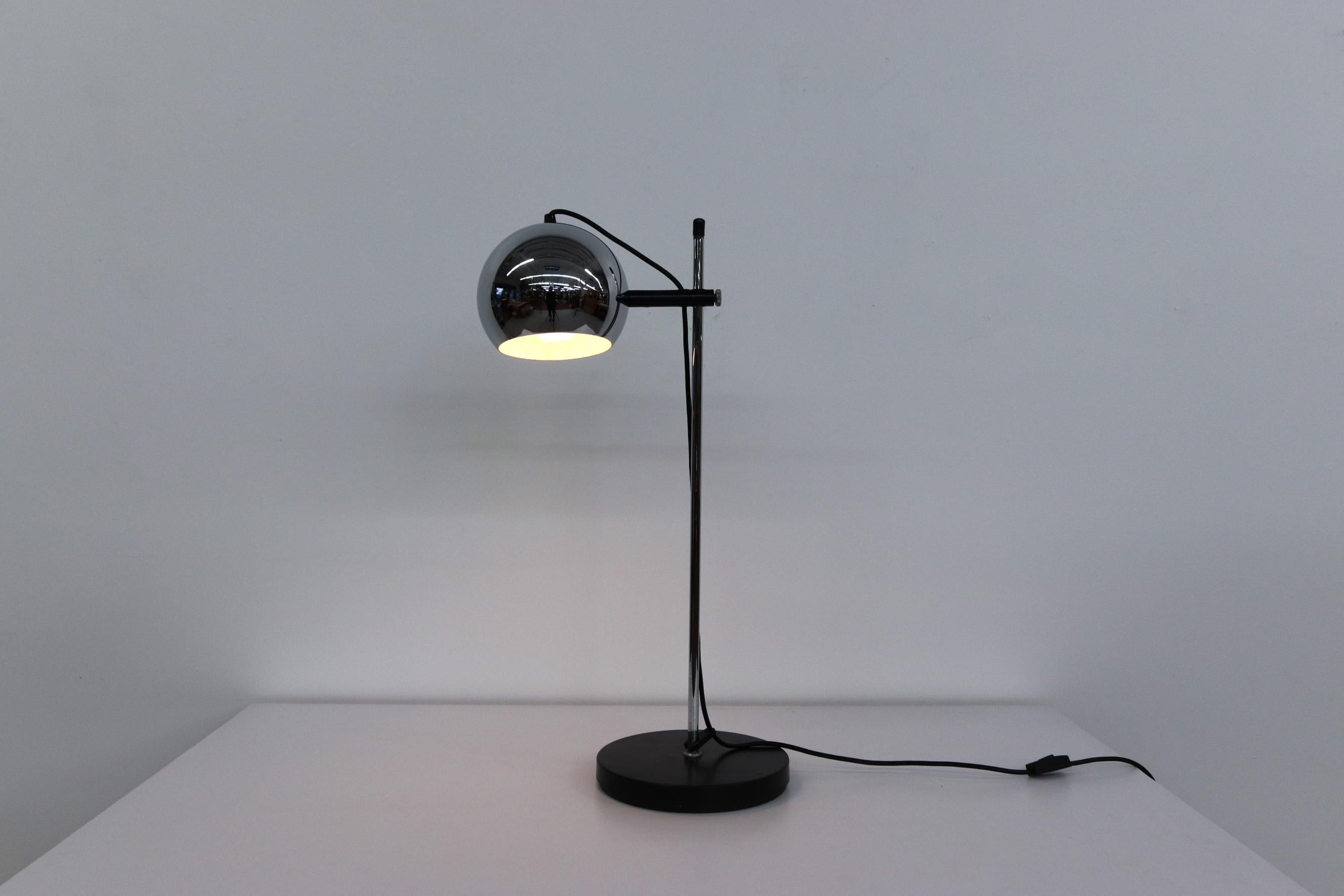 Mid century, Gepo (attr) chome globe table lamp with black base. Adjustable height and rotating globe. In original condition with visible wear consistent with age and use.