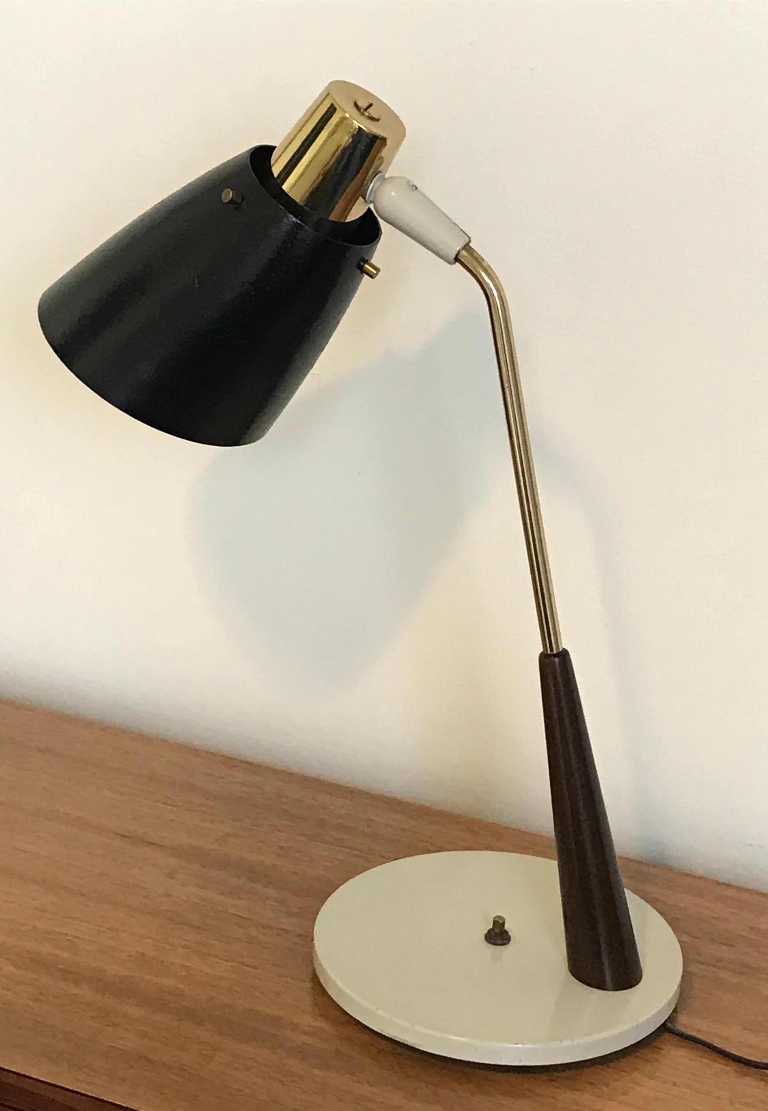 Very chic midcentury articulating desk lamp by Gerald Thurston for Lightolier. Professionally restored and rewired.