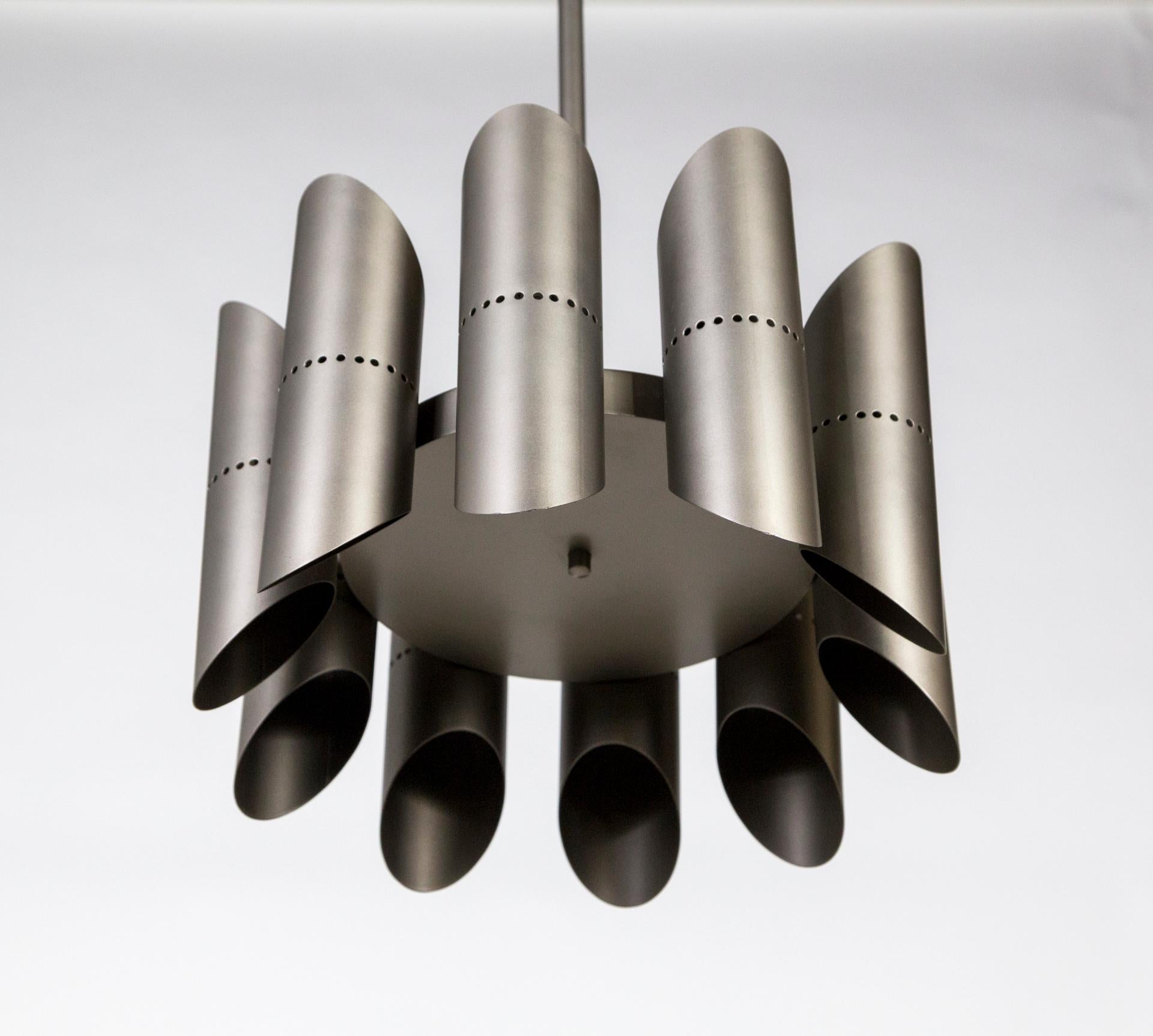 A German pendant light from the 1950s in a sleek design of 10 pipes mounted around a disk. Newly powder coated in antique silver tone. 10 sockets, newly rewired. 16