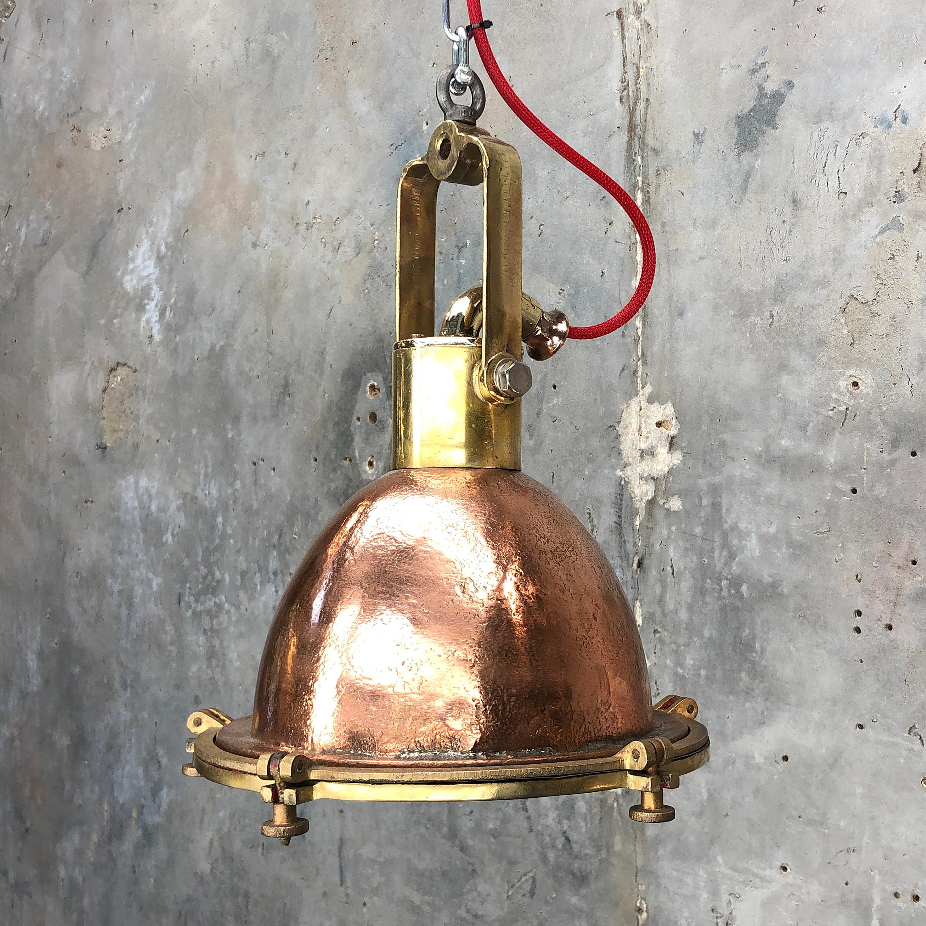 A beautifully aged copper and brass vintage Industrial pendant lamp.

Originally marine lighting fixtures, these pendant have been reclaimed from cargo ships made in the 1960s in Germany where they were used to illuminate cargo bays of sea going