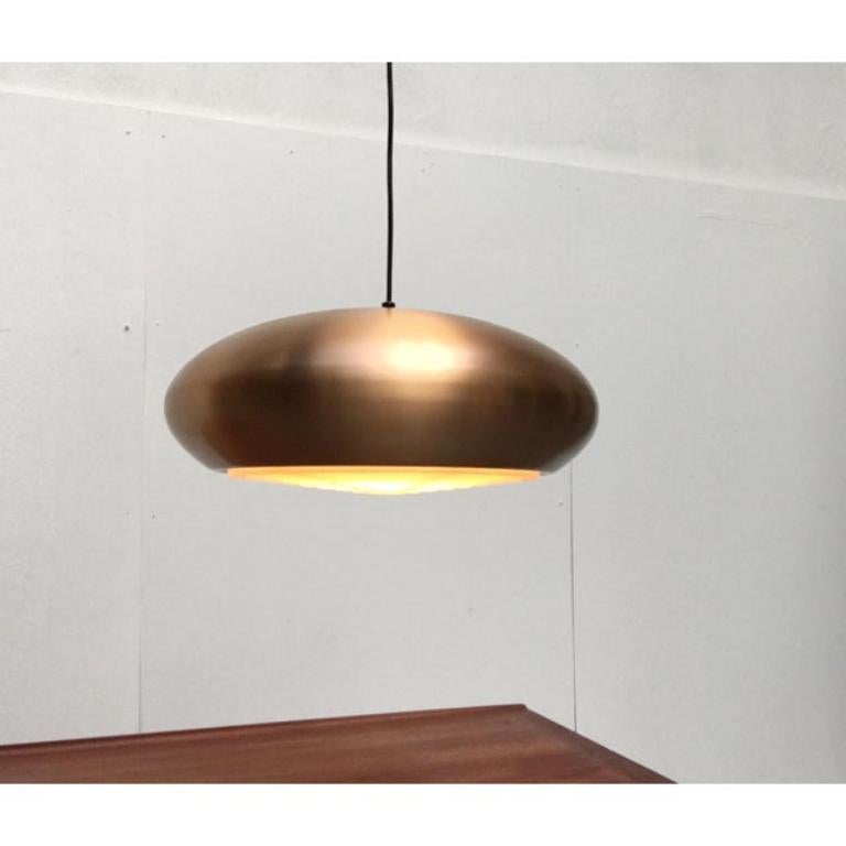 Large Mid Century pendant lamp from the renowned manufacturer Goldkant.

The lamp convinces with its simple yet striking shape, which is inspired by Scandinavian aesthetics. This probably also results in the copper-colored finish of the outer