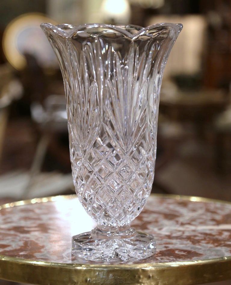 Decorate a side table or enfilade with this elegant antique vase. Crafted in Germany circa 1960 of the Hampton Hall line, the tall neoclassical vase sits on a round base and embellished with a wide mouth at the top. The Classic, cut crystal vase is