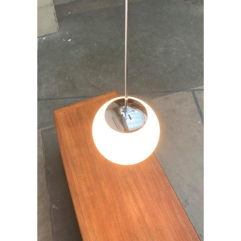 Simple Mid Century Glass Ball Pendant Light.
Classic pipe pendulum with ball. Perfect for the old building ceiling. The diffuser ball is made of hand-blown opal glass with shiny surface. The pipe, canopy and housing are made of chromed metal. The