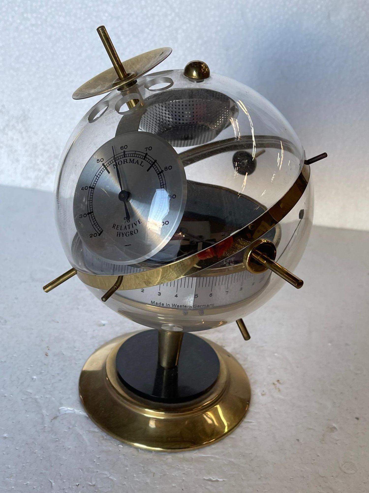 Mid Century German Made acrylic and brass Weather Station Relative Hygrometer this sphere with Barometer Hygrometer & Thermometer.

West Germany, circa 1960