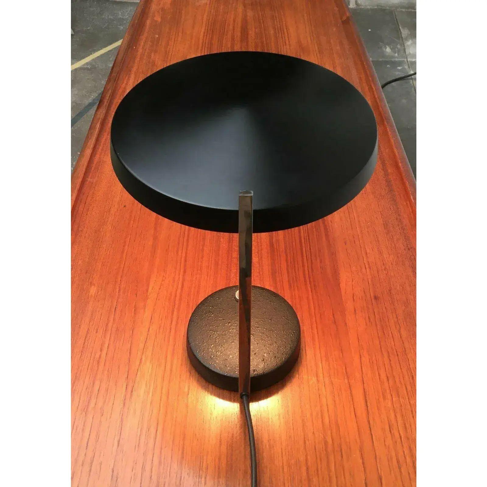 Oslo table lamp by Hillebrand Leuchten based on a design by Heinz Pfänden from the early 1960s.

What is striking is the particularly flat shape of the umbrella with the slight dome in the middle. The base and shade are in the same color and