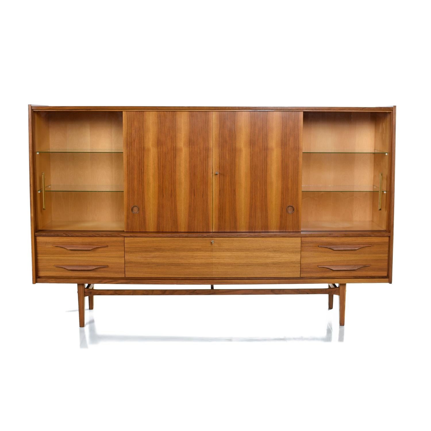 This is not a typical Rockabilly German Shrunk cabinet. This piece, although authentically German, is clearly Scandinavian inspired. The most obvious Danish aspect is the old growth, heartwood teak. Fiery cathedral grain can only be found in vintage