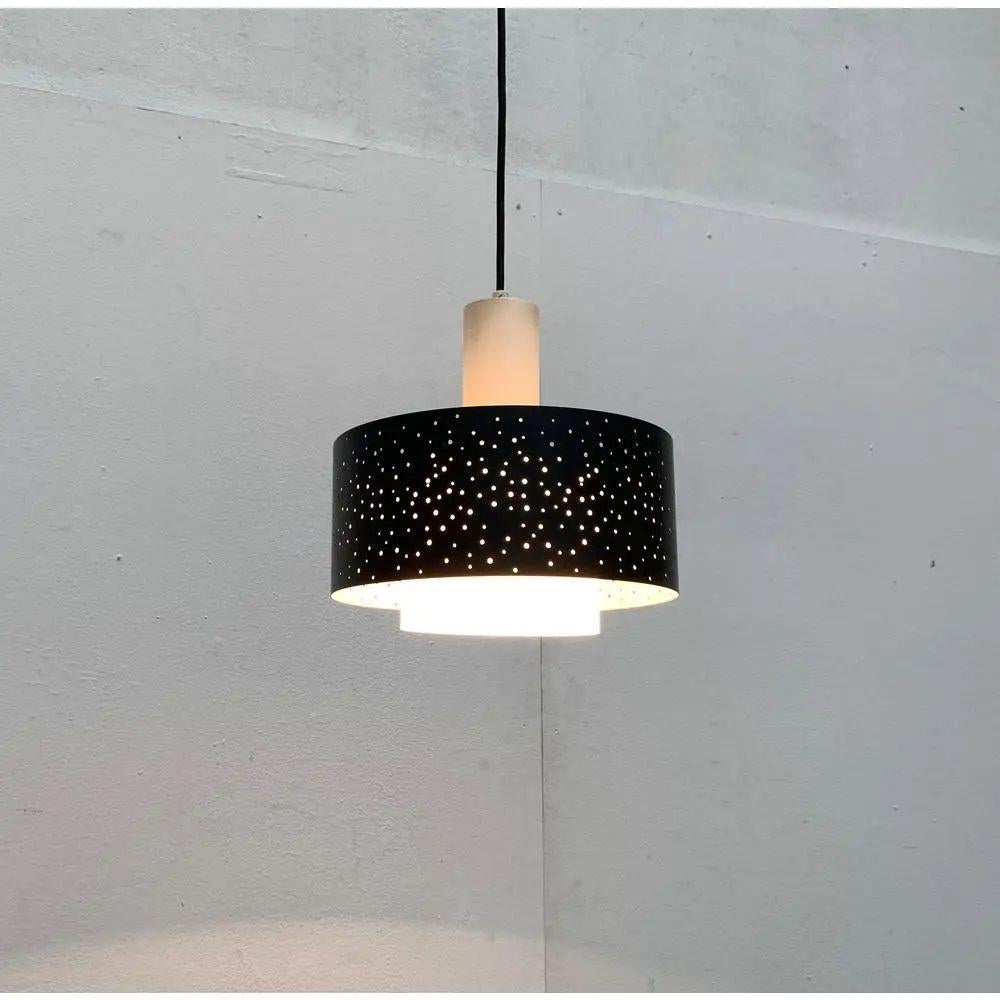 Rare Mid-Century pendant lamp with distinctive perforation from the renowned Hillebrand based on a design by Ernest Igl from the 60s.

The lamp consists of three elements. The glare ring forms the central element. Above is a plain, white lacquered