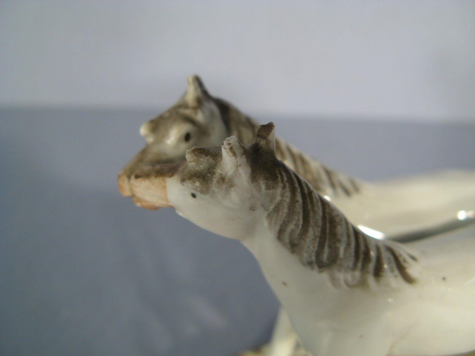 This charming mid-century German porcelain figurine, featuring two graceful horses, adds a touch of rustic charm to any home décor. The intricate details and hand-painted accents showcase the craftsmanship of the era, making this piece a true