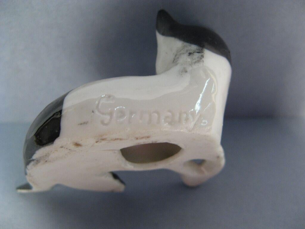 This charming mid-century German porcelain resting cat figurine adds a touch of feline charm and European flair to any home décor. The intricate details of the cat's features and the delicate porcelain construction make it a delightful addition to