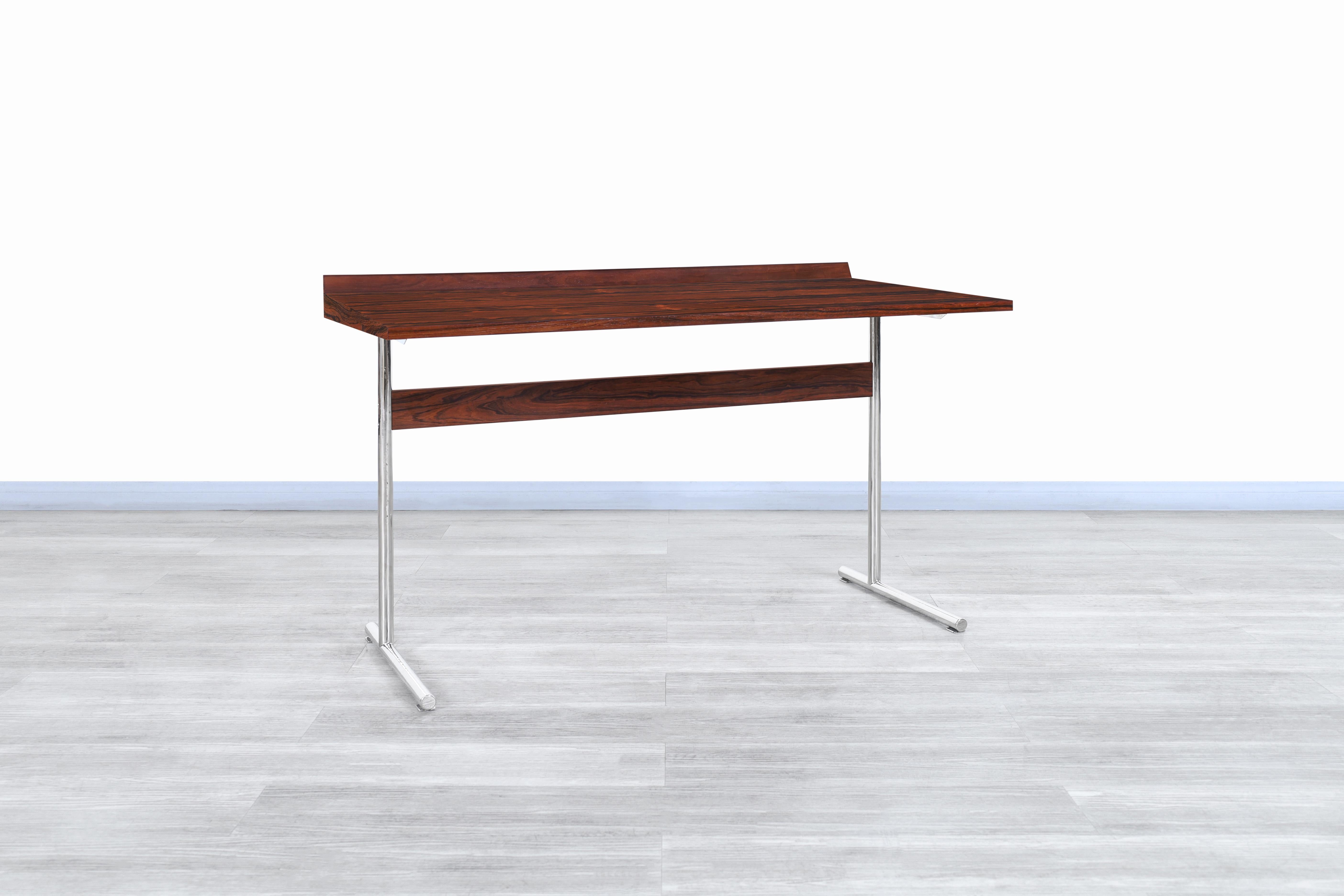 Wonderful midcentury rosewood “Omega” desk designed by Hans Eichenberger for Haussmann and Haussmann in Germany, circa 1950s. This desk has a Minimalist but highly functional design. The desk has been built from rosewood, which offers an elegant