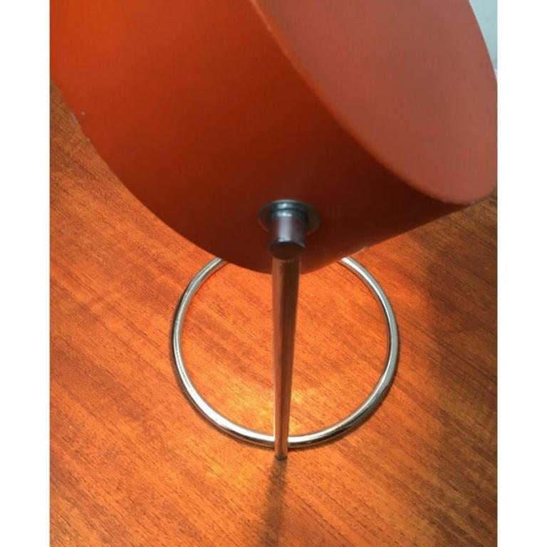 Mid Century Table Lamp from Cosack with movable shade.

The reflector shade of the lamp is held by hinges on two webs. For example, the screen can be tilted manually control the direction of light. The chrome-colored foot is dissolved in a ring. The