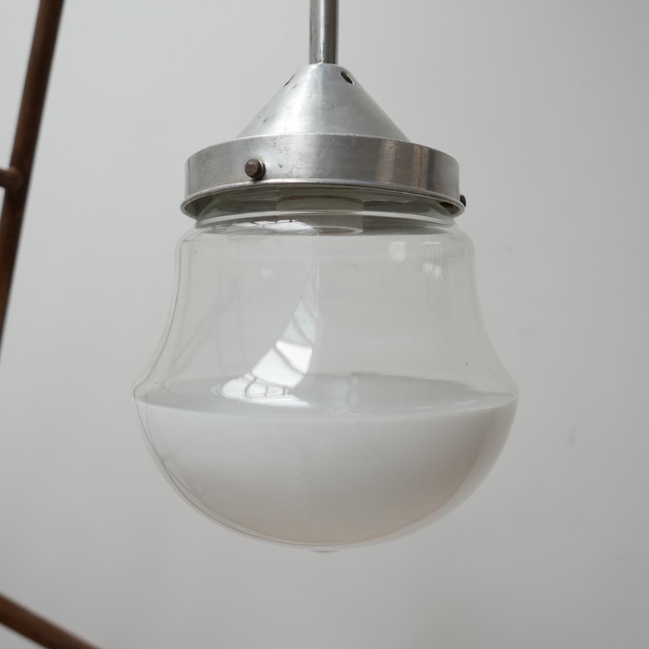 A mid-century pendant light. 

Two tone glass, with an opaline base and clear top. 

Long metal stem gallery. 

The glass terminates in an open hole. 

Germany, c1950s. 

Re-wired and PAT tested. 

Delivery: POA.



 