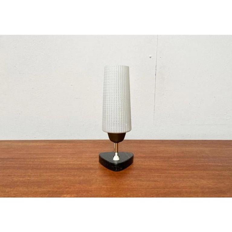 Rare mid century table lamp by Werner Lorenz with a special foot. This piece has an attribution mark, European Plug (up to 250V). The wiring of this item may be original and might need replacement, if not specified otherwise.

Additional