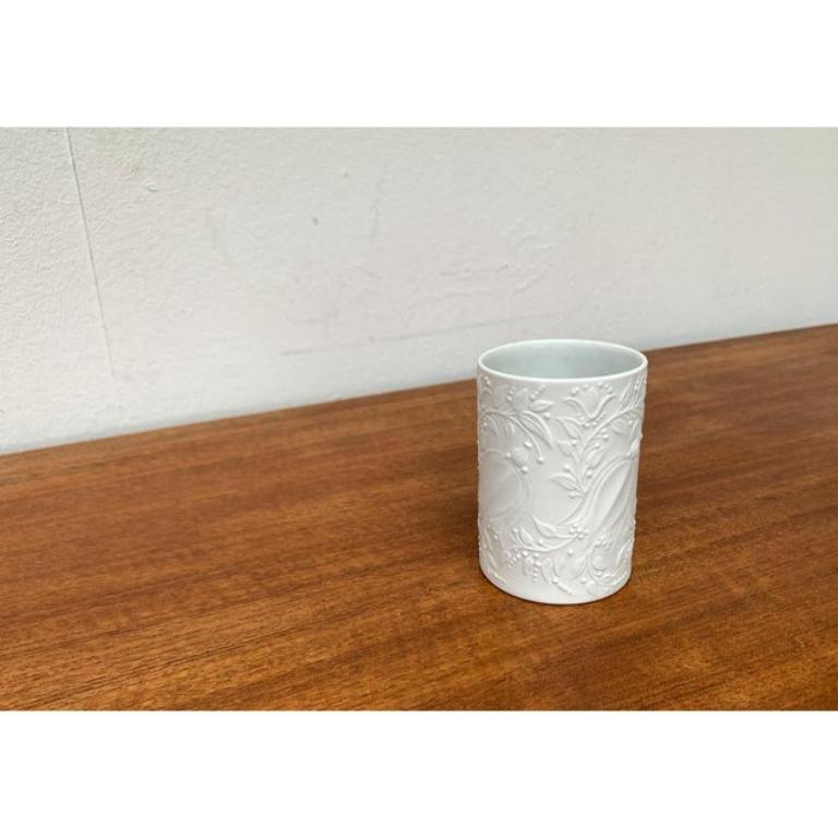 Elegant, white porcelain vase according to a design by Bjørn Wiinblad from the 1960s. The decor is embedded shows a fine relief with a matt finish. This piece has an attribution mark.

Additional information:
Materials: Porcelain
Style: Mid-Century