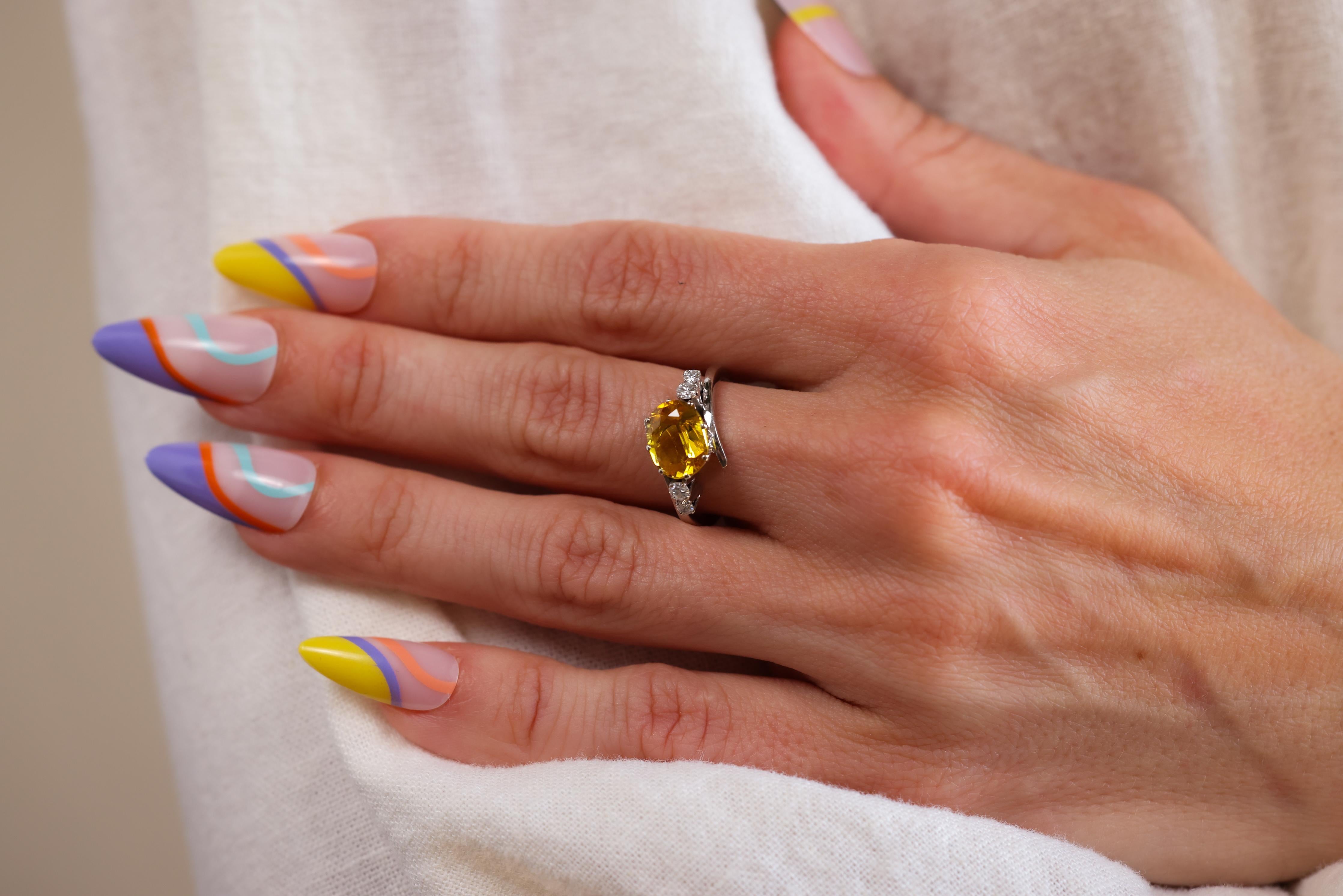 Certificate: GIA
Center Stone: Yellow Sapphire
Cut: Oval Brilliant
Weight: Approximately 2 Carats
Origin: Thailand
Treatment: Heated 
Accent Stone: 4 Diamonds
Cut: Round Brilliant 
Weight: Approximately 0.2 Carat
Color: F
Clarity: VS/SI
Metal: 14
