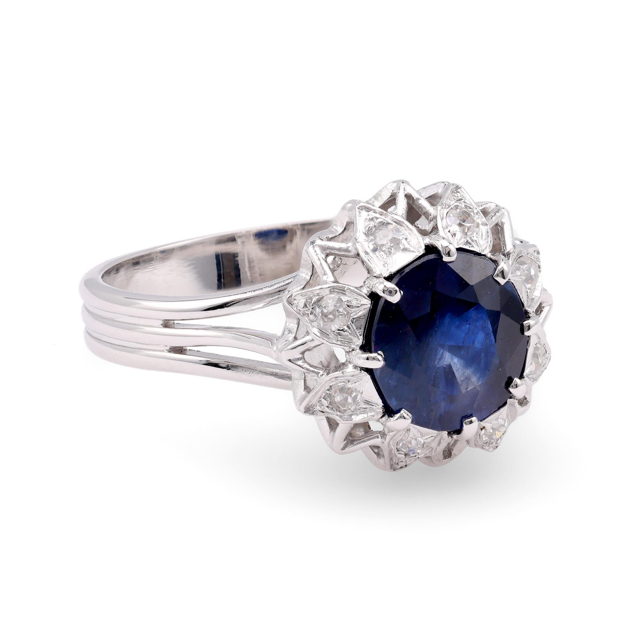 Center Stone: Sapphire
Certificate: GIA  #5202979107
Cut: Oval
Weight: 2.21 Carat
Color: Blue
Origin: Madagascar
Treatments: No Indications Of Heating
Accent Stone: 8 Diamonds
Cut: Single
Weight: Approximately 0.2 Carats
Color: G
Clarity: SI
Metal:
