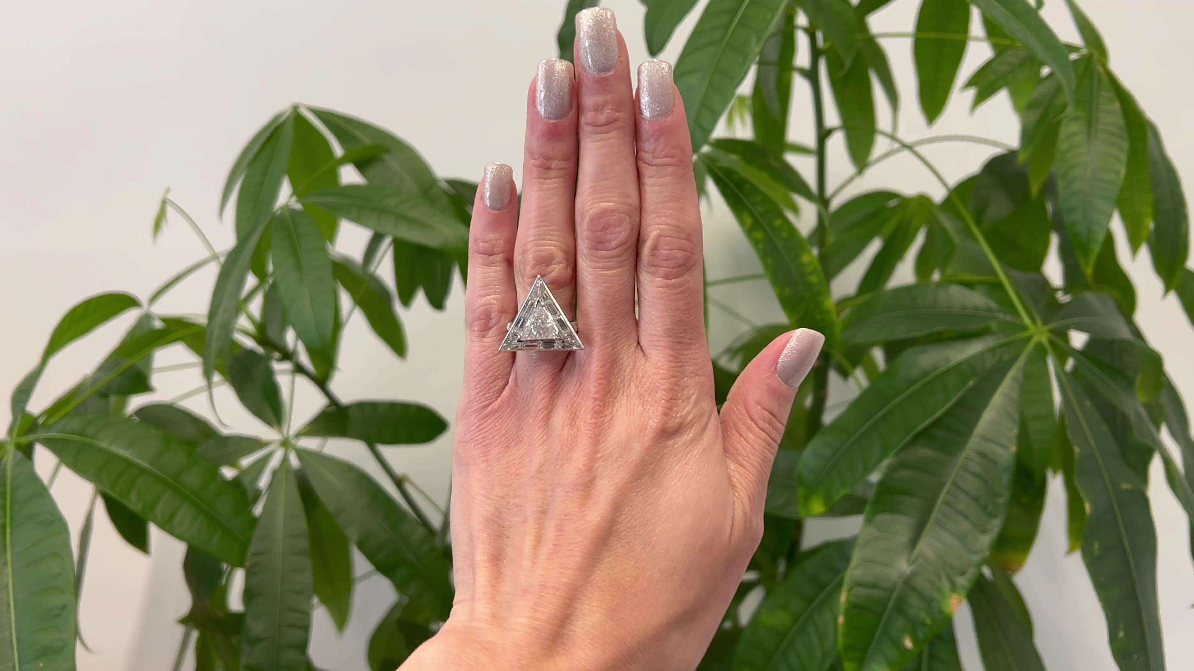 One Mid Century GIA 2.45 Carats Diamond Platinum Triangle Cocktail Ring. Featuring one GIA triangular step cut of 2.45 carats, accompanied with GIA #1226735641 stating the diamond is F color, SI2 clarity. Accented by 14 baguette cut diamonds with a