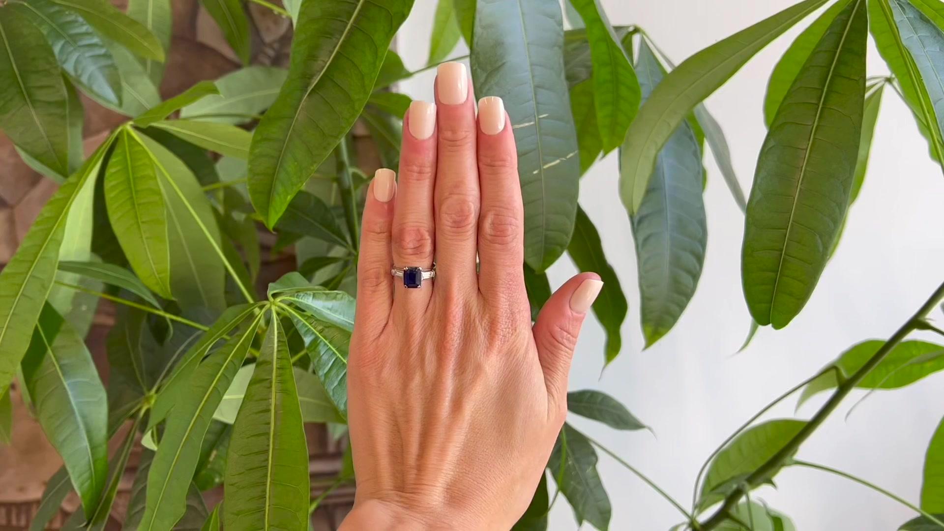One Mid Century GIA 2.56 Carats Sri Lanka Sapphire Diamond Platinum Ring. Featuring one GIA octagonal step cut dark blue sapphire of 2.56 carats, accompanied with GIA #5222632747 stating the sapphire is of Sri Lanka origin. Accented by two baguette