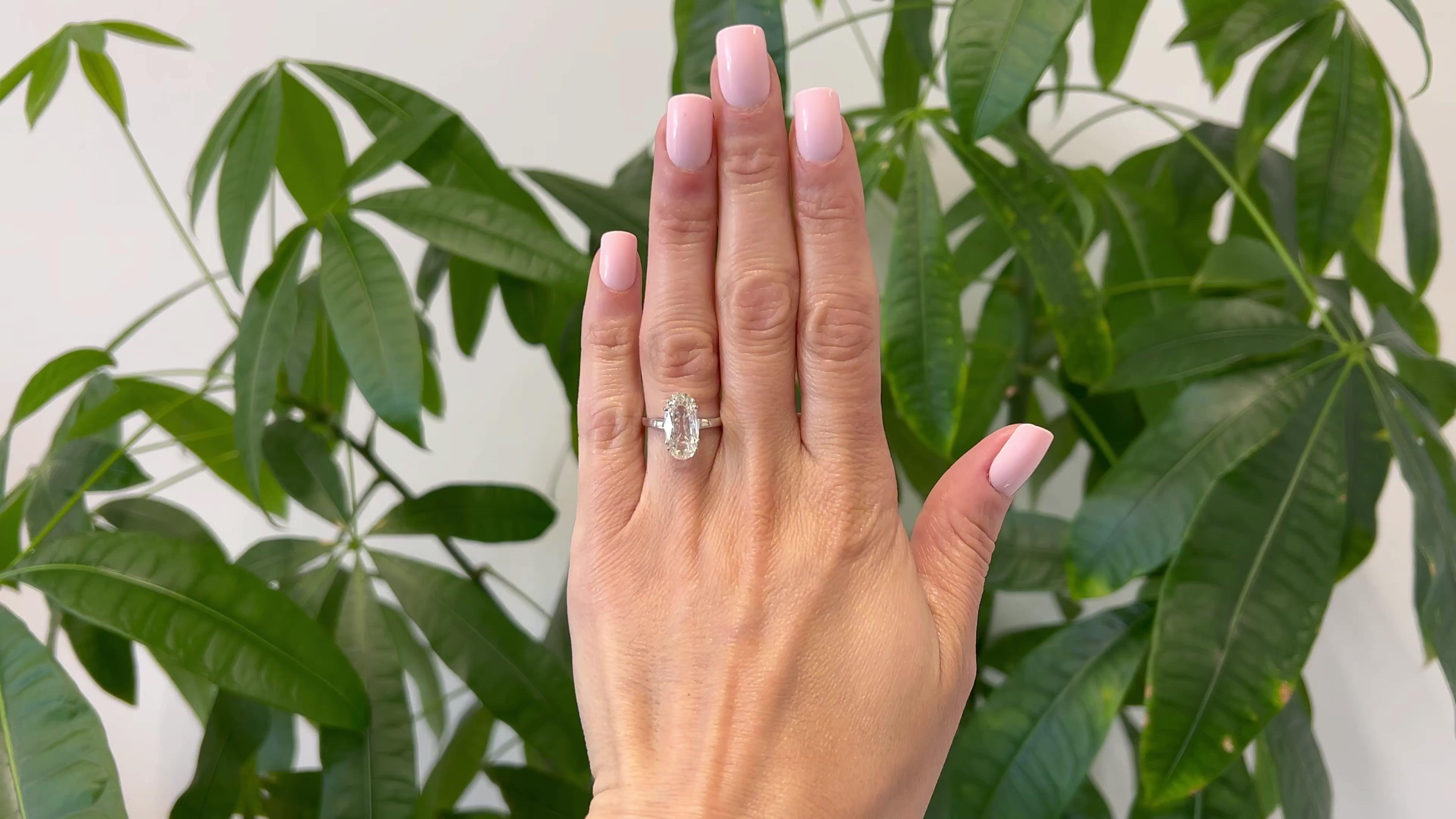 One Mid Century GIA 3.06 Carat Oval Cut Diamond 18k White Gold Ring. Featuring one GIA oval cut diamond of 3.06 carats, accompanied with GIA #1445899159 stating the diamond is L color, I2 clarity. Accented by two tapered baguette cut diamonds with a