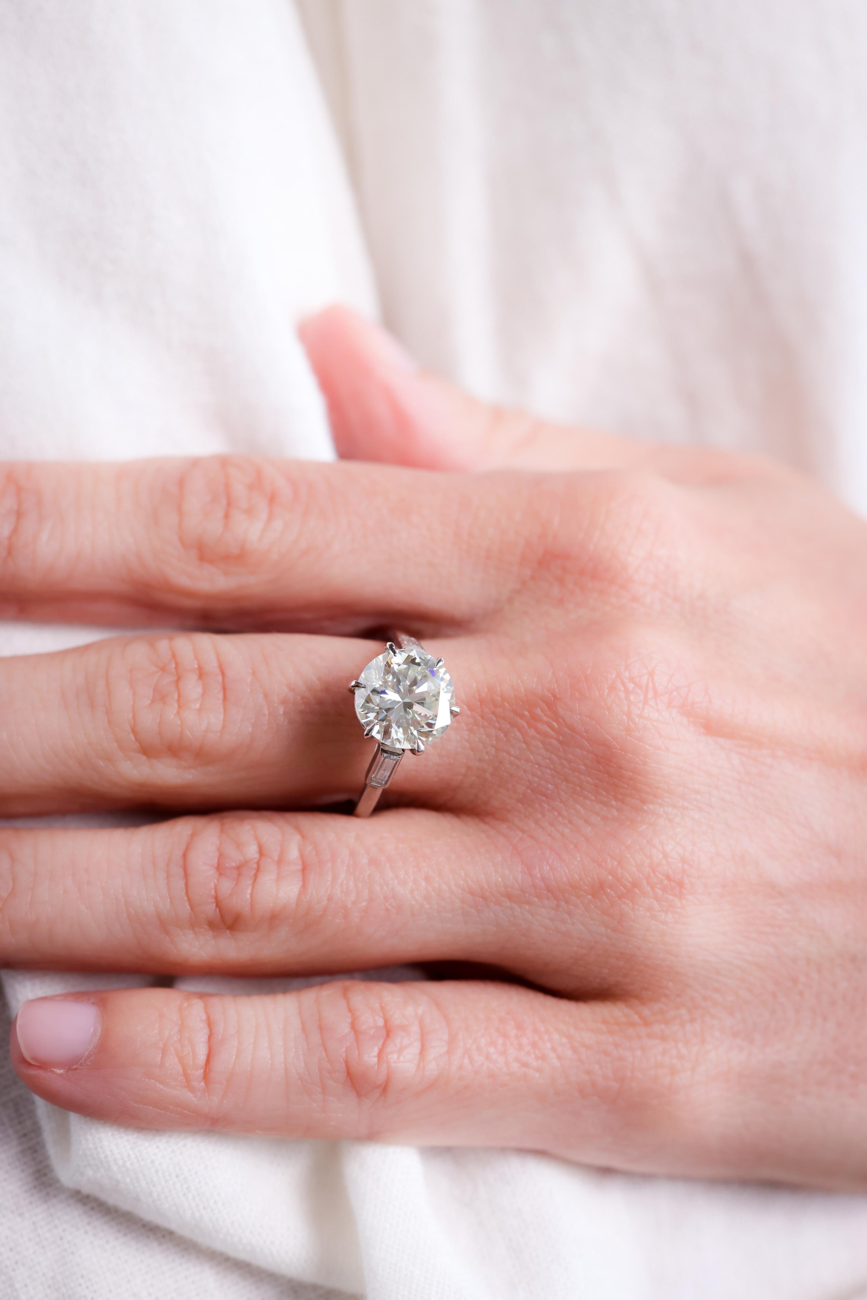 Center Stone: Diamond
Certificate: GIA #15835427
Cut: Round Brilliant
Weight: 3.77 Carat
Color: L
Clarity: SI1
Accent Stone: 2 Diamonds
Cut: Baguette
Weight: Approximately 0.4 Carats
Color: I
Clarity: SI
Metal: Platinum Bottom and 18K White Gold