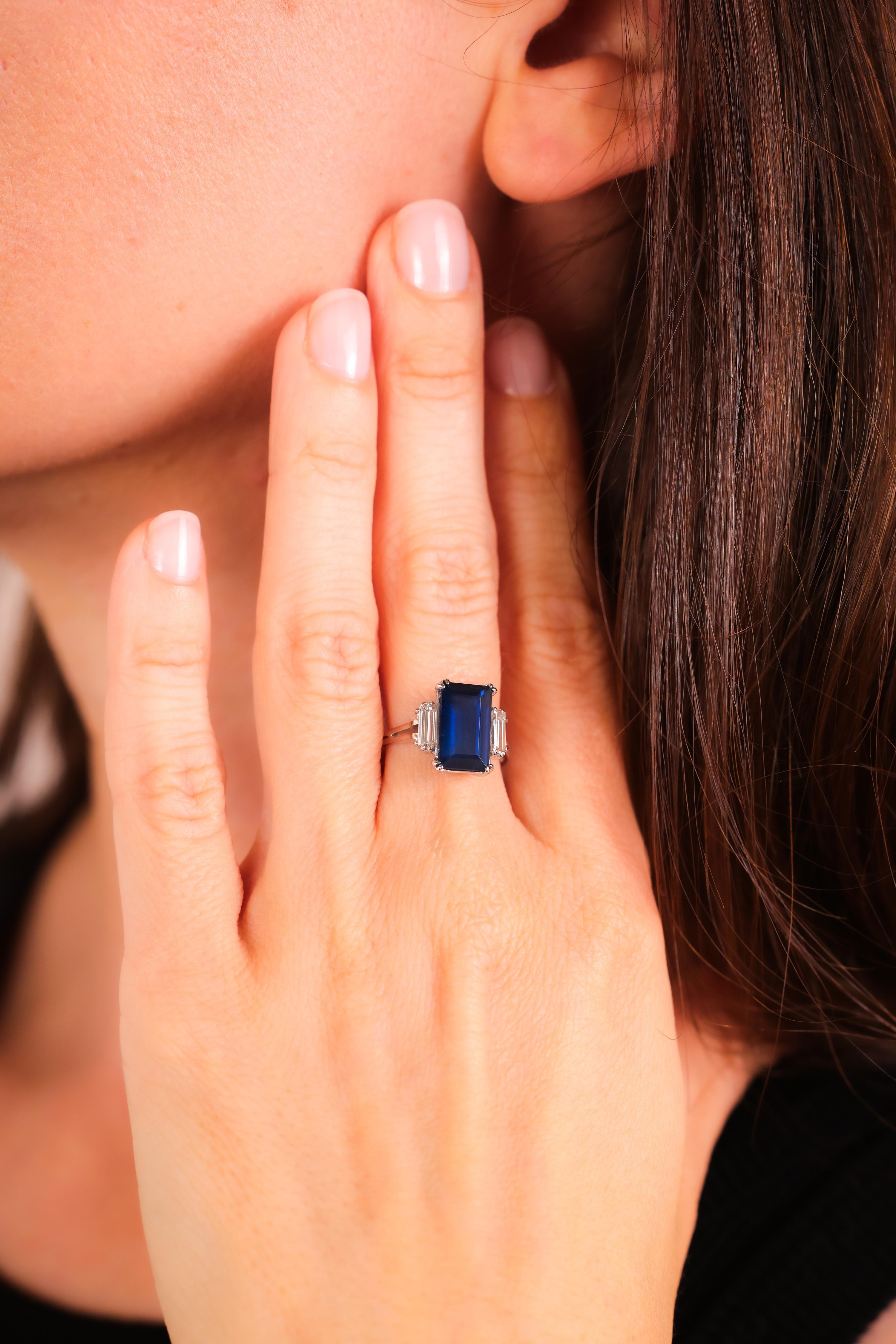 Center Stone: Sapphire
Certificate: GIA  #2231209623
Cut: Rectangular Step Cut
Weight: 4.22 Carat
Color: Blue
Origin: Thailand
Treatments: Heated
Accent Stone: 2 Diamonds
Cut: Baguette
Weight: Approximately 0.5 Carats
Color: G
Clarity: VS
Metal: 18K