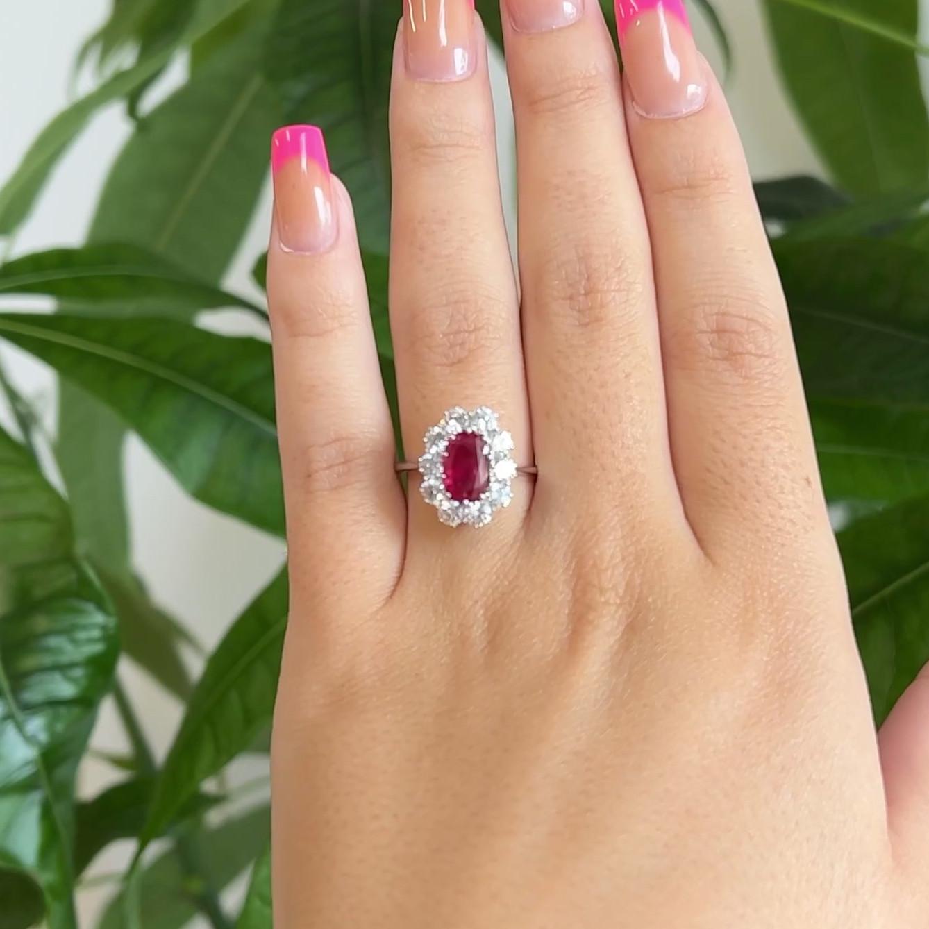 One Mid Century GIA No Heat Burma Ruby Diamond 18 Karat White Gold Halo Ring. Featuring one GIA certified oval shaped ruby of approximately 1.13 carats, accompanied with certificate #5221441280 stating the ruby is Burma in origin, with no